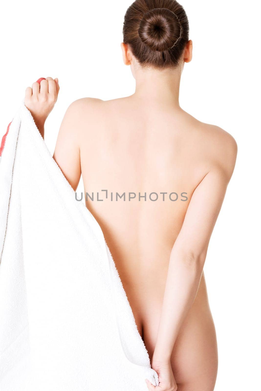 attractive naked woman's back covered with towel. isolated on white.