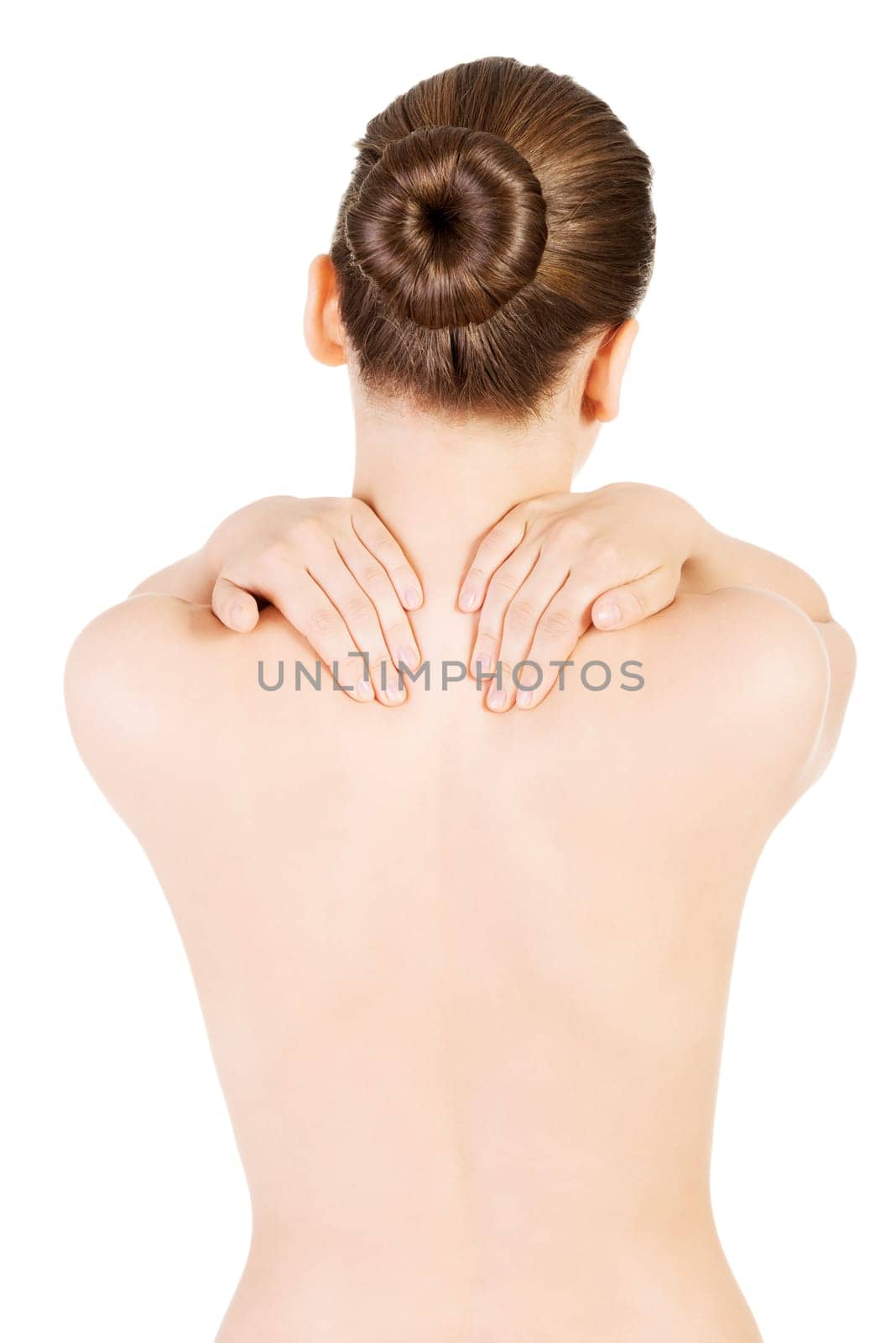 attractive woman trying to touch both hands on her back. isolated on white.