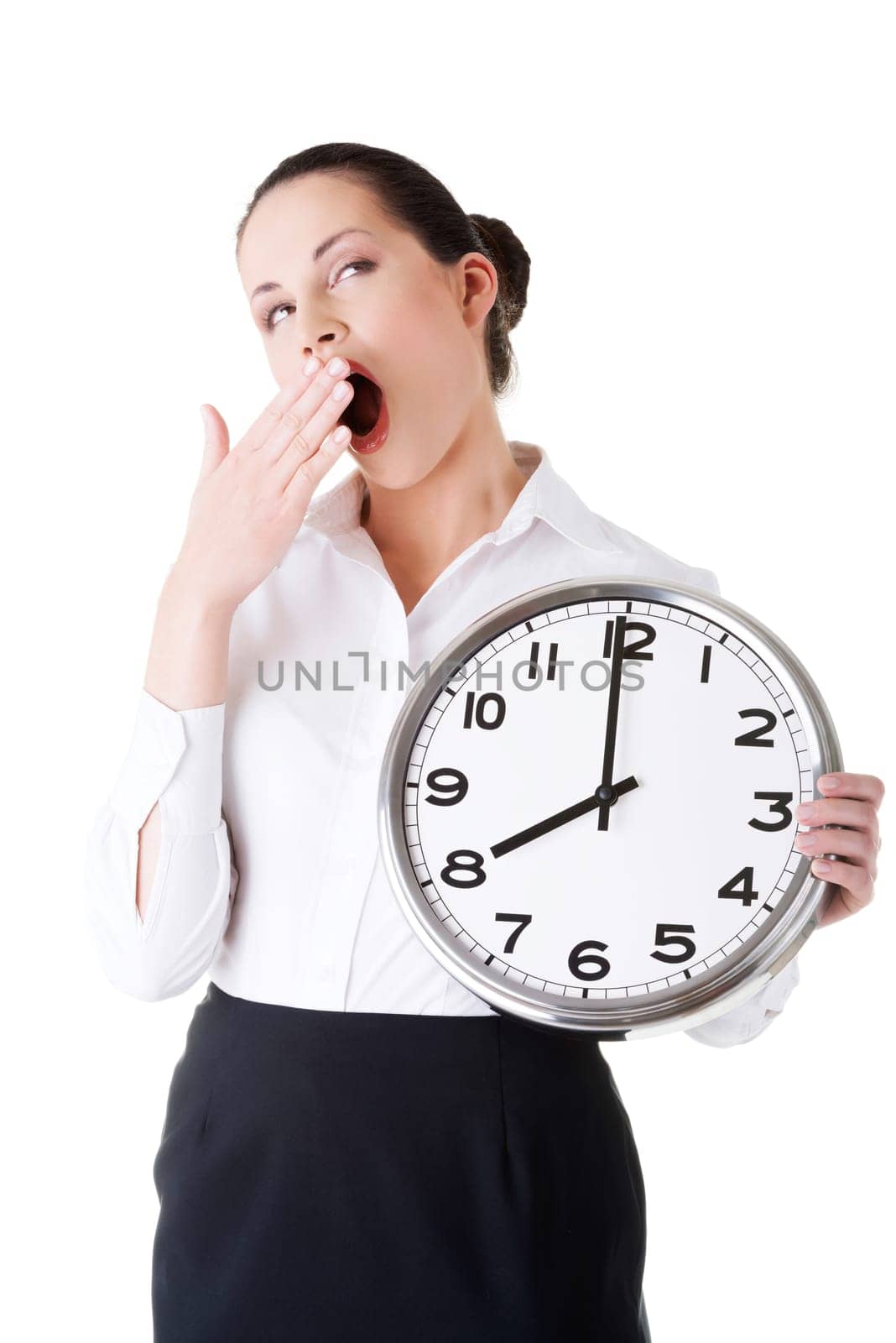 business woman holding a clock and yeaning. isolated on white.