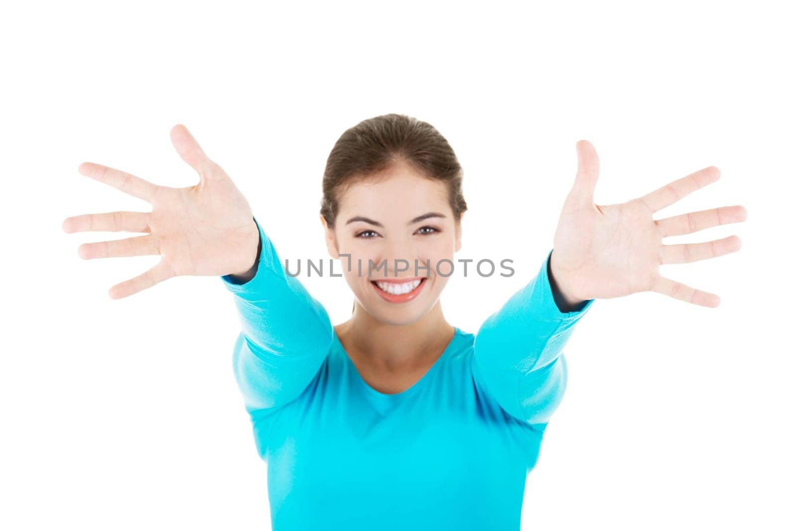attractive young woman wiht hands open in front on her. isolated on white.