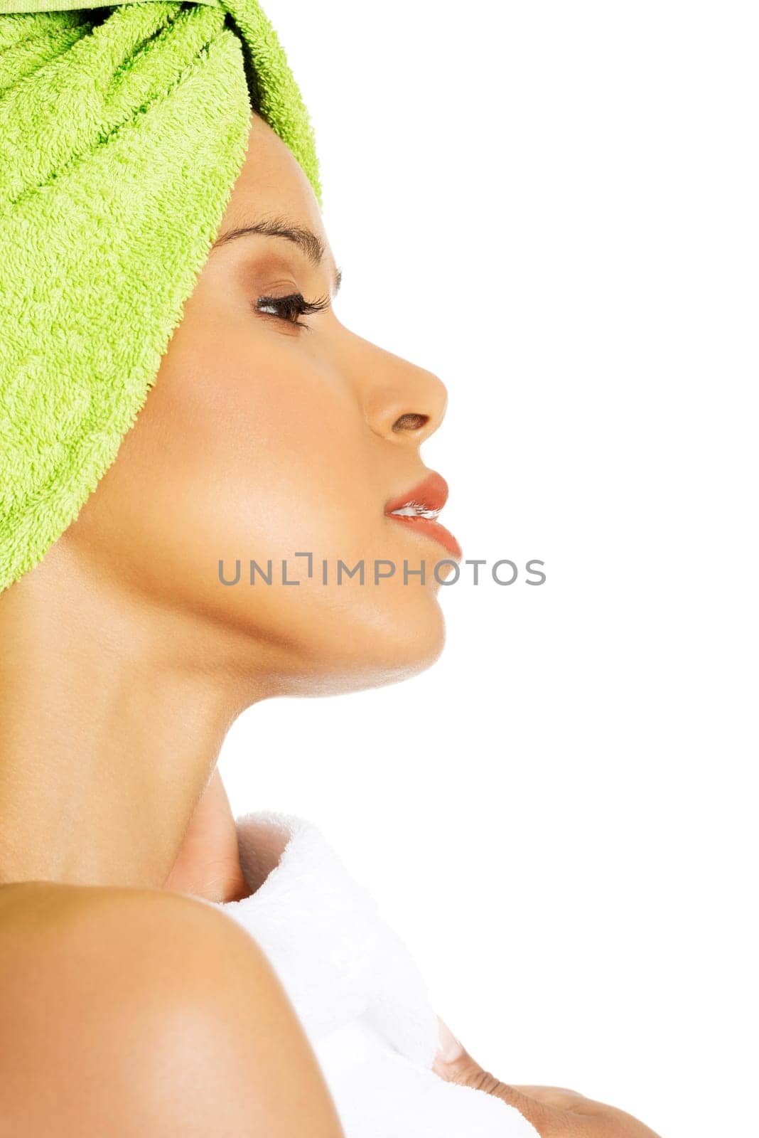 profile of attractive woman wrapped in towel with a turban. isolated on white.