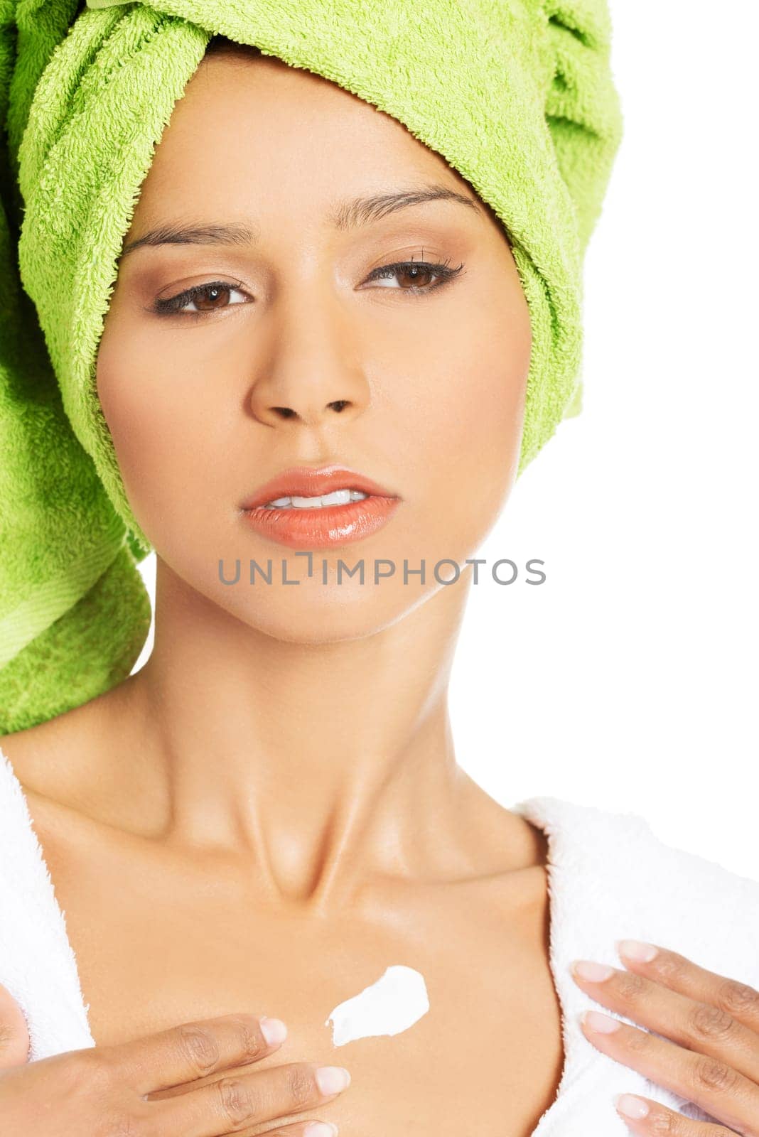 attractive woman applying body lotion on chest. isolated on white.