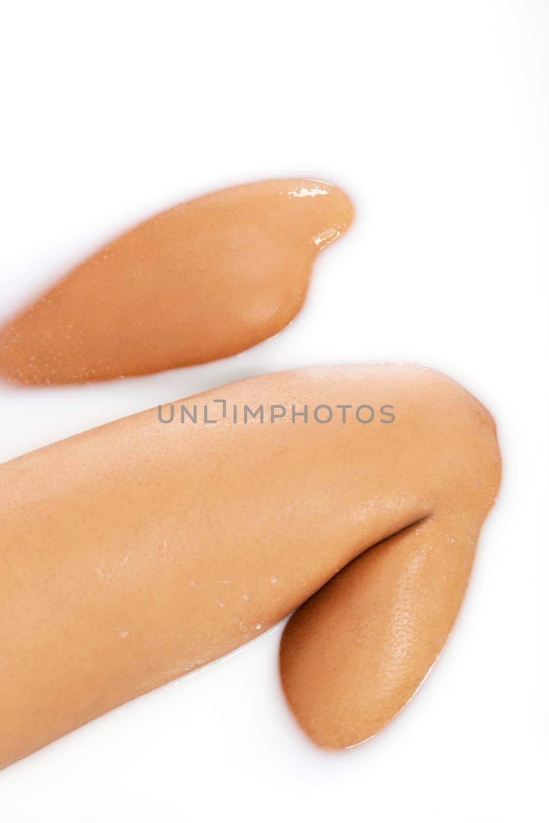 female legs in milk bath. up front view. closeup.