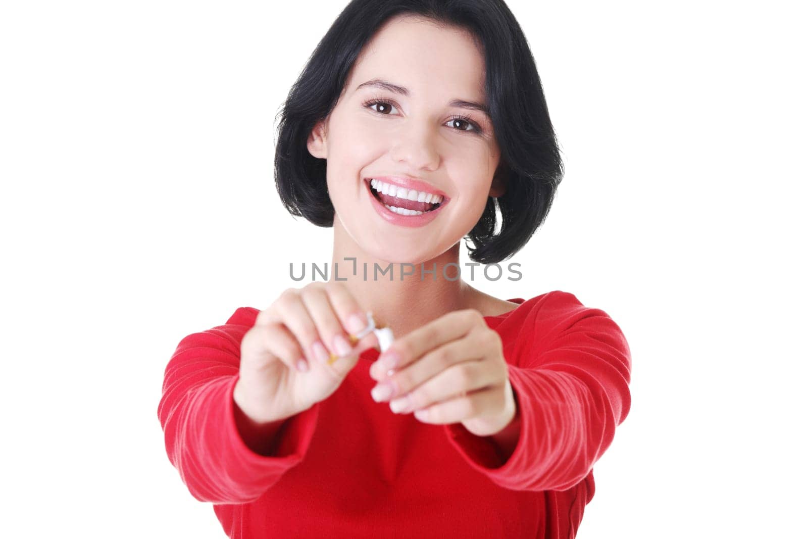 attractive woman holding a broken cigarette. isolated on white.