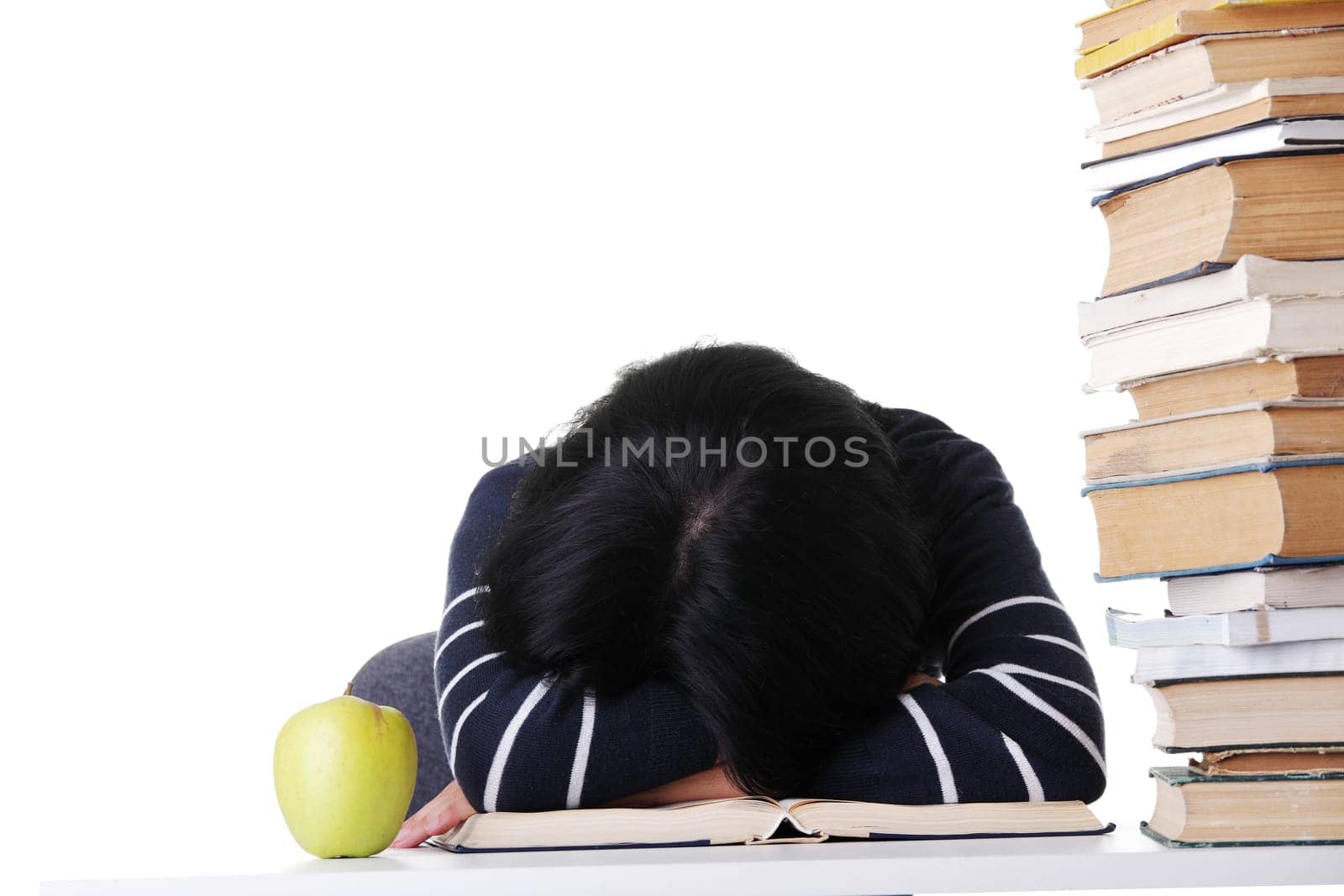 attractive woman sleeping by stack of books. isolated on white.