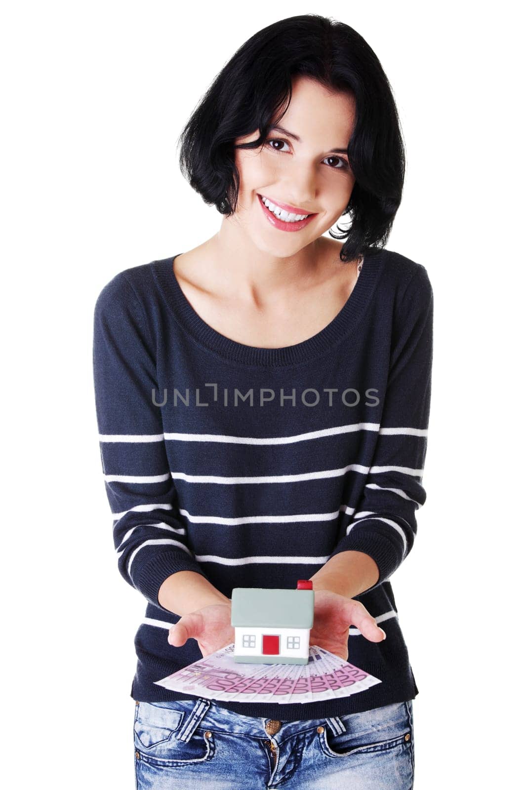 attractive girl with money and house on hands. isolated on white.