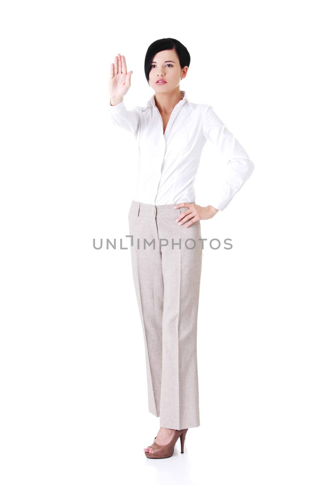 attractive young woman showin stop by hand. isolated on white.