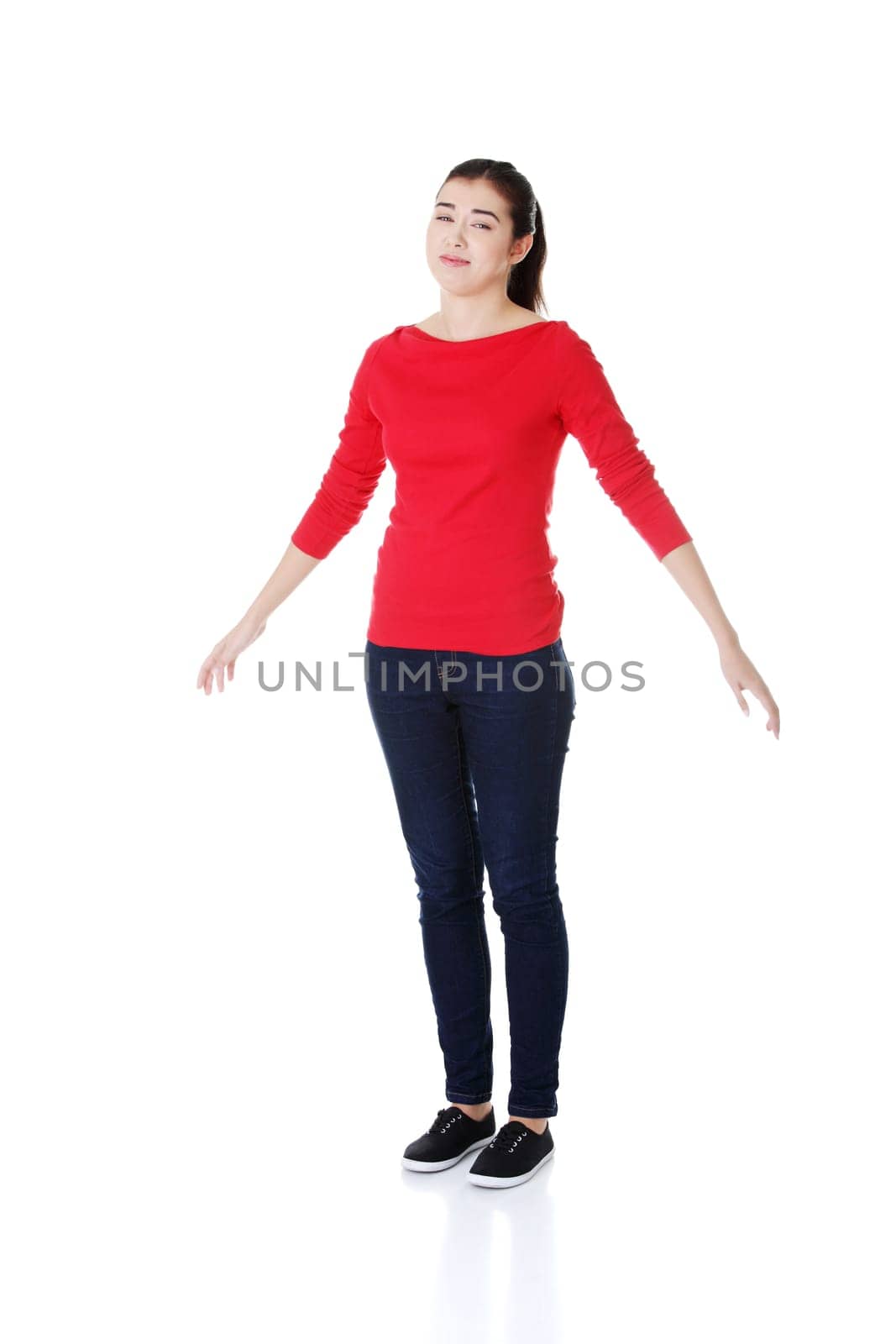 attractive woman with spread hands down. isolated on white.