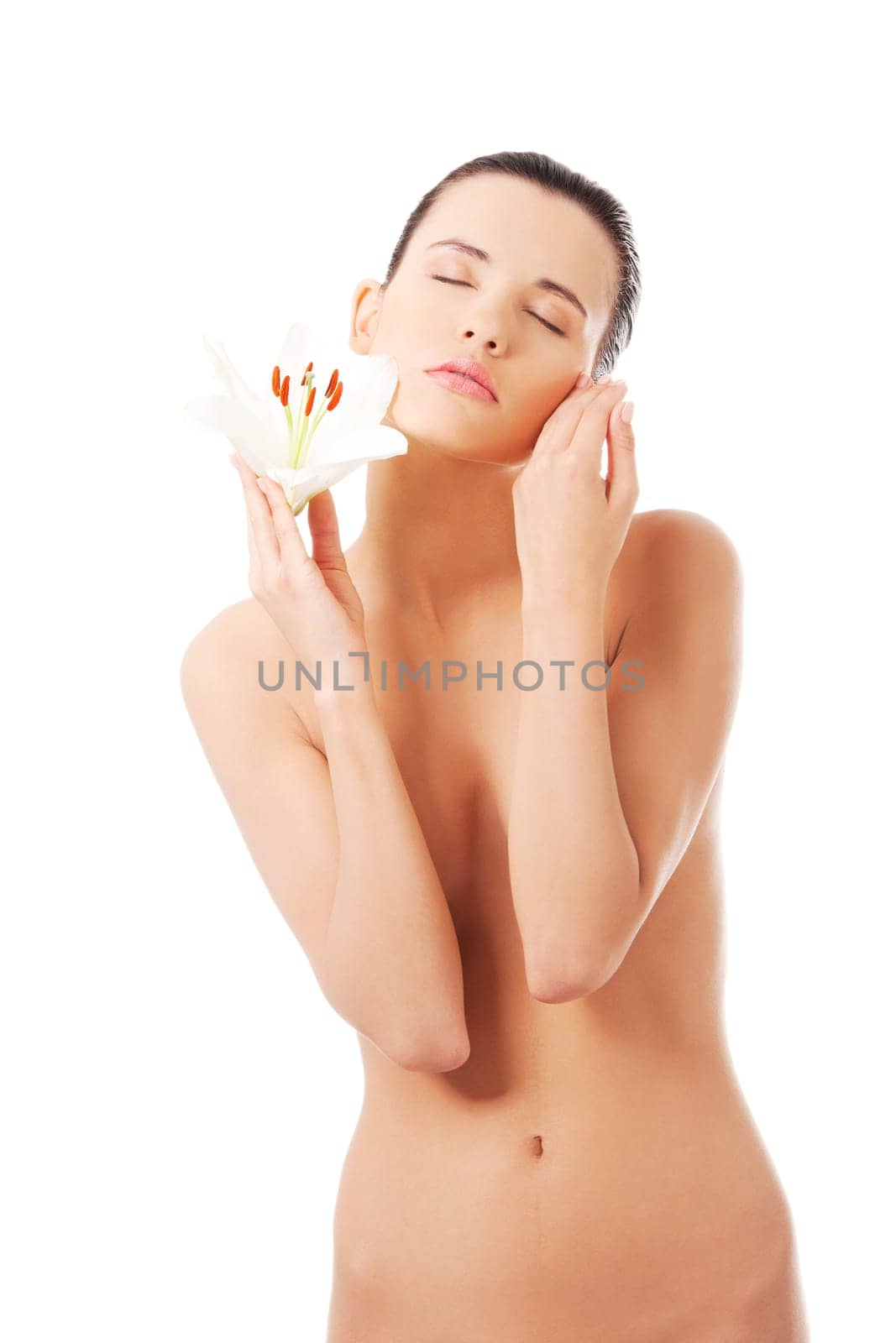 young attractive naked woman with lily flower. isolated on white.