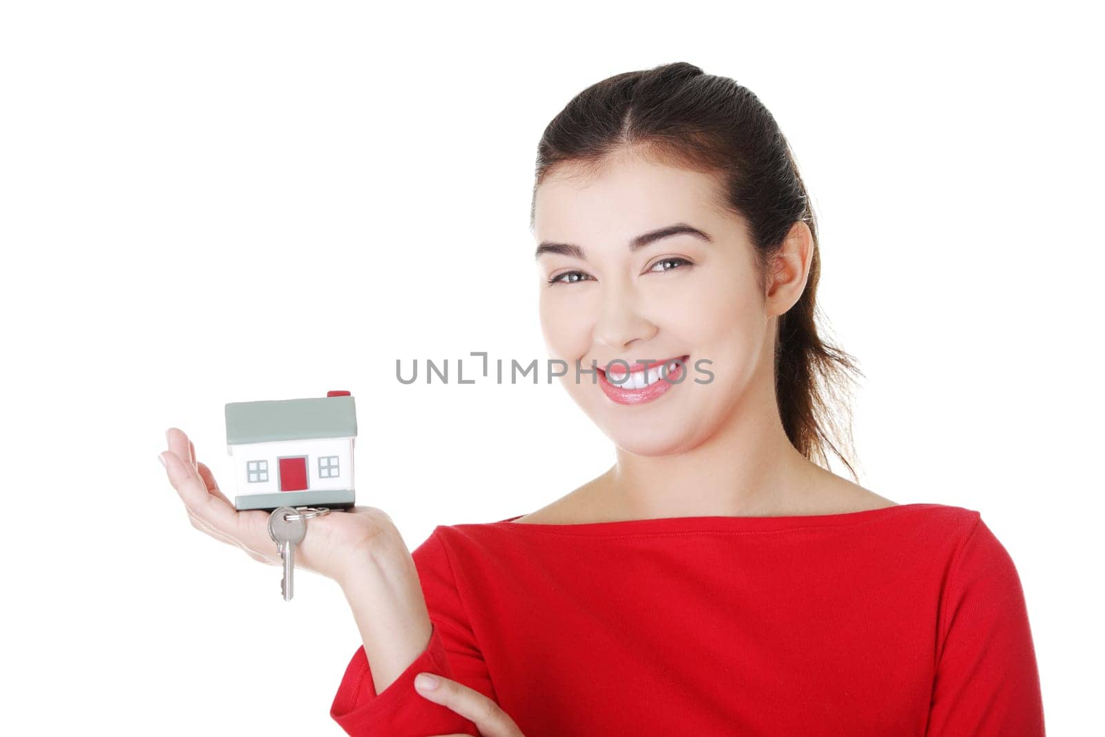 happy casual woman holding home keys. isolated on white.
