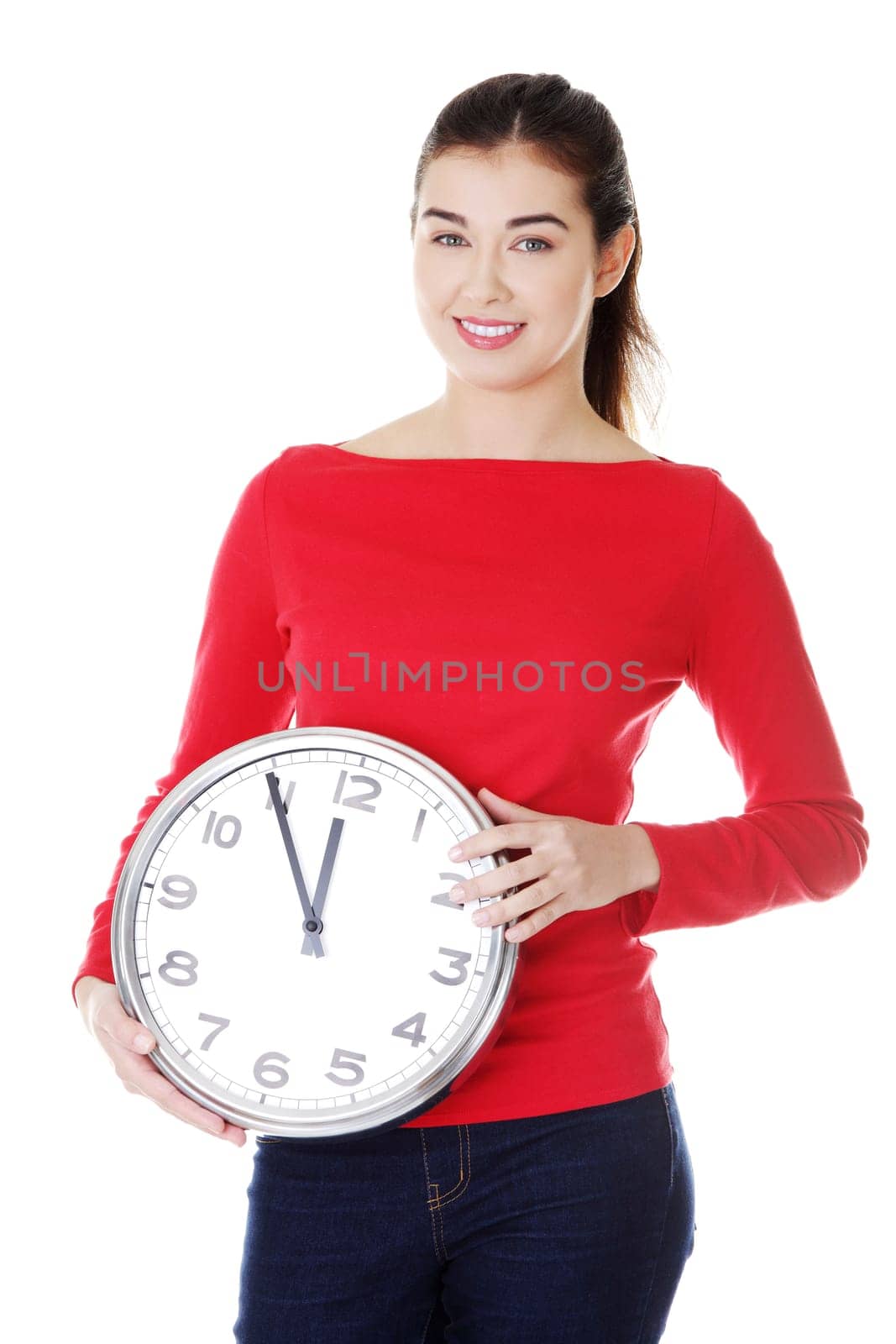 attractive young woman holding a clock. isolated on white.