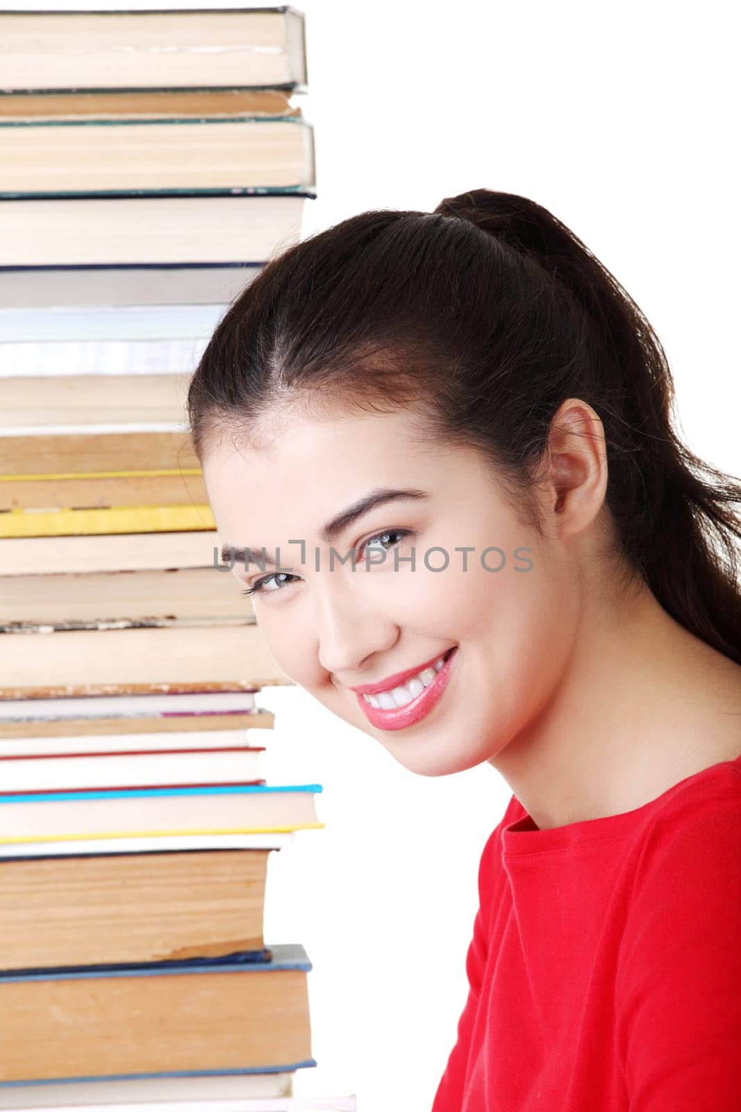attractive young woman with stack of books. isolated on white.