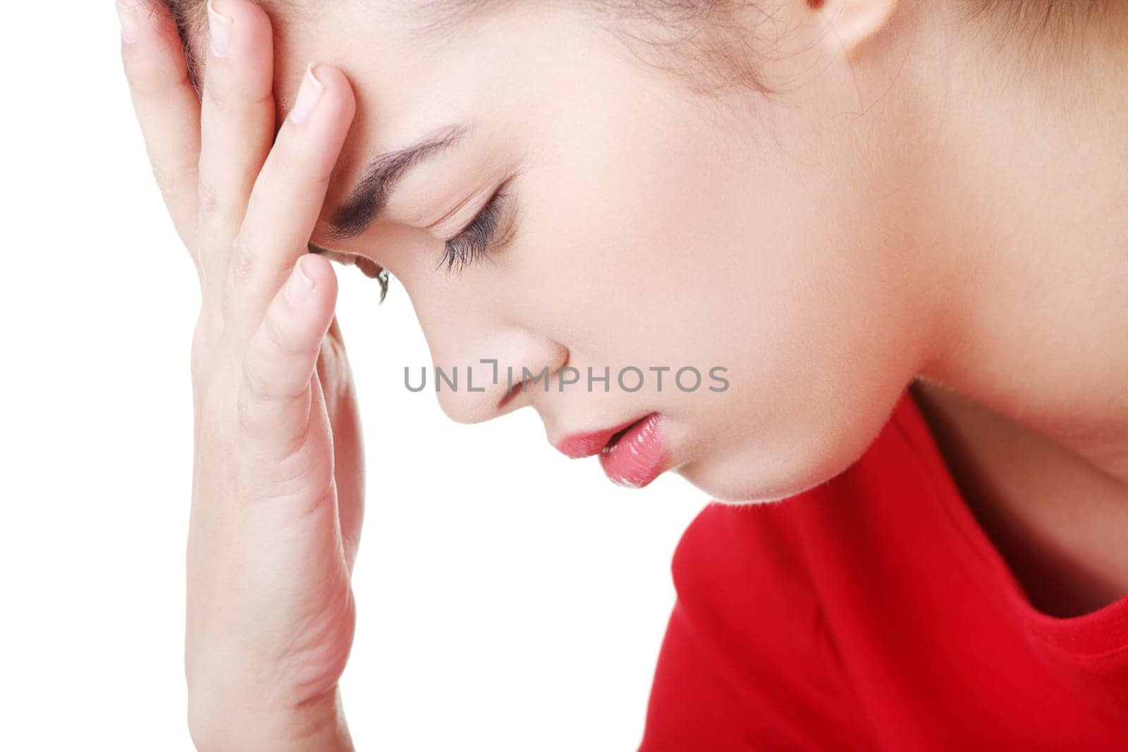 casual woman holding her head. isolated on white.