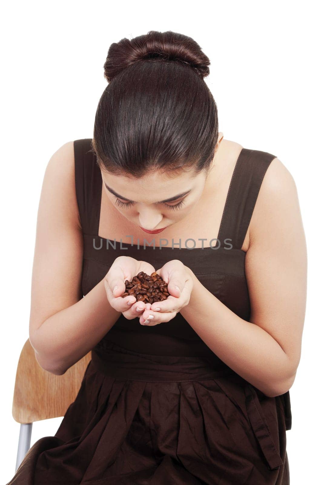 beautiful woman sitting holdig and coffee beans in hands. isolated on white.