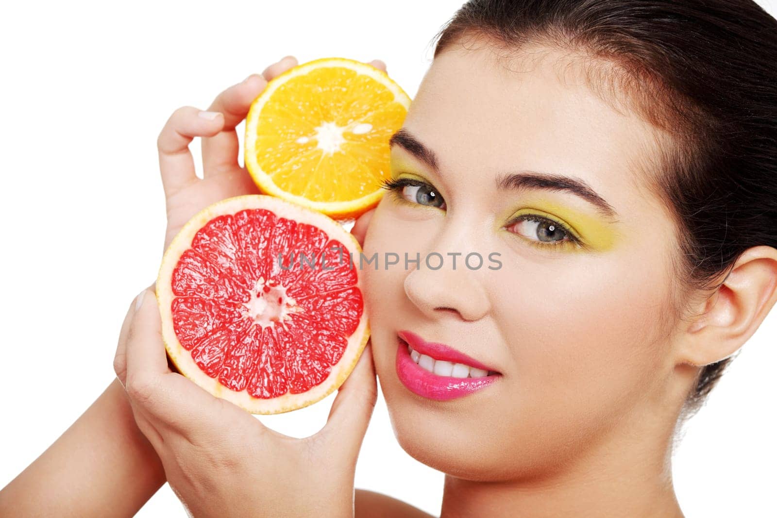 beautiful woman's face with orange and grapefruit. isolated on white.