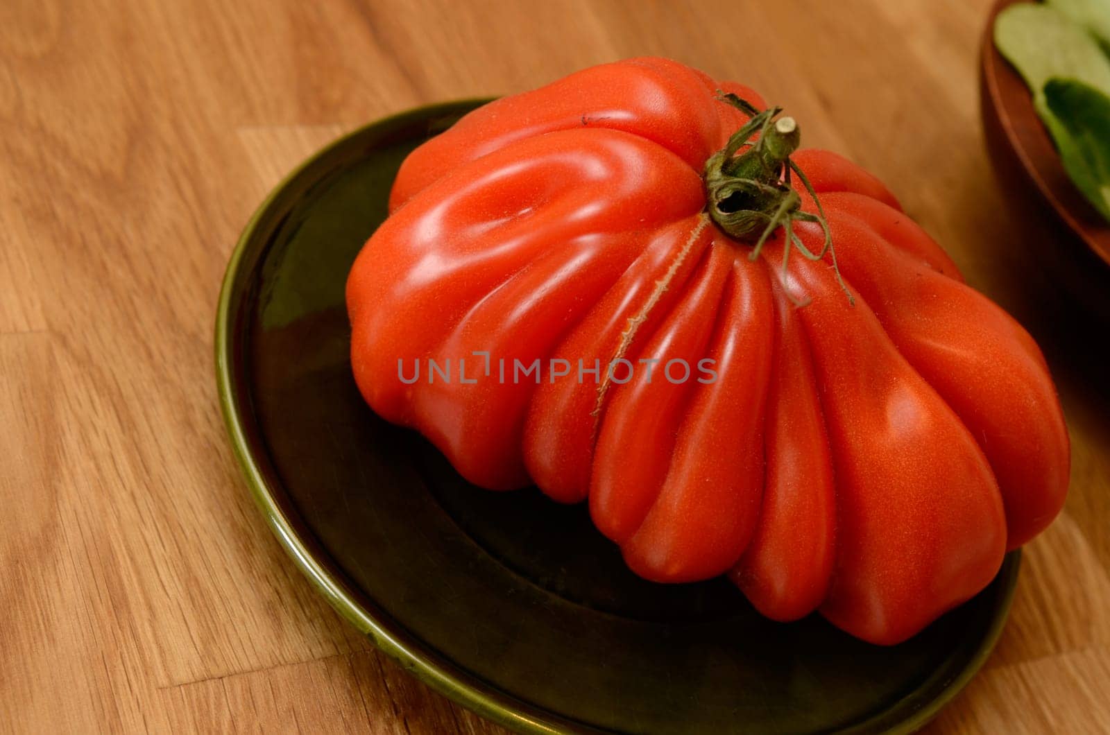 Big tomato on a wooden table