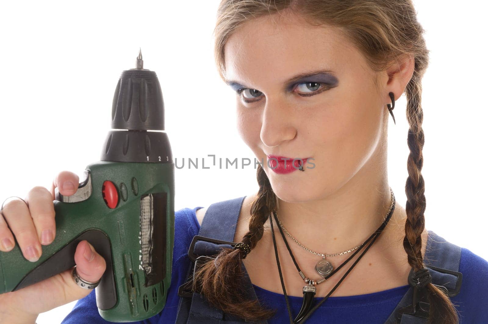 Wildew's teenage girl as a trainee (apprentice) with blue man (work suit) and braids poses with a cordless Borhschrauber against a white background