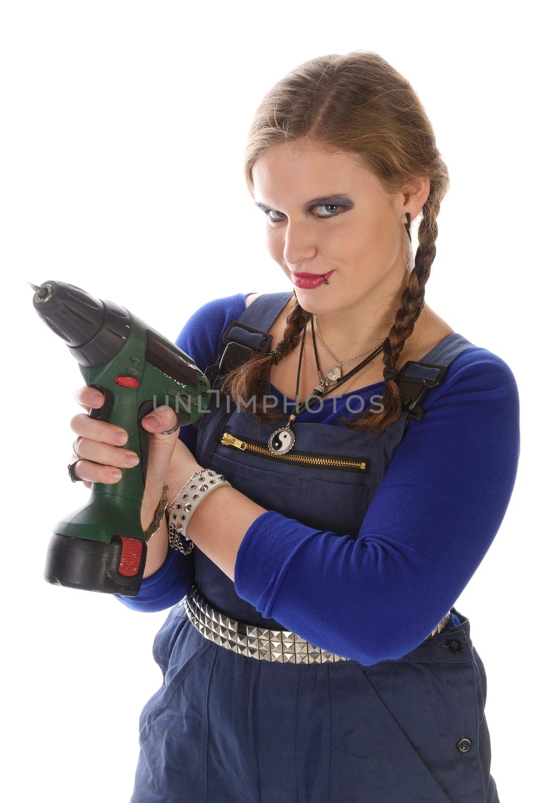 Wildew's teenage girl as a trainee (apprentice) with blue man (work suit) and braids poses with a cordless Borhschrauber against a white background