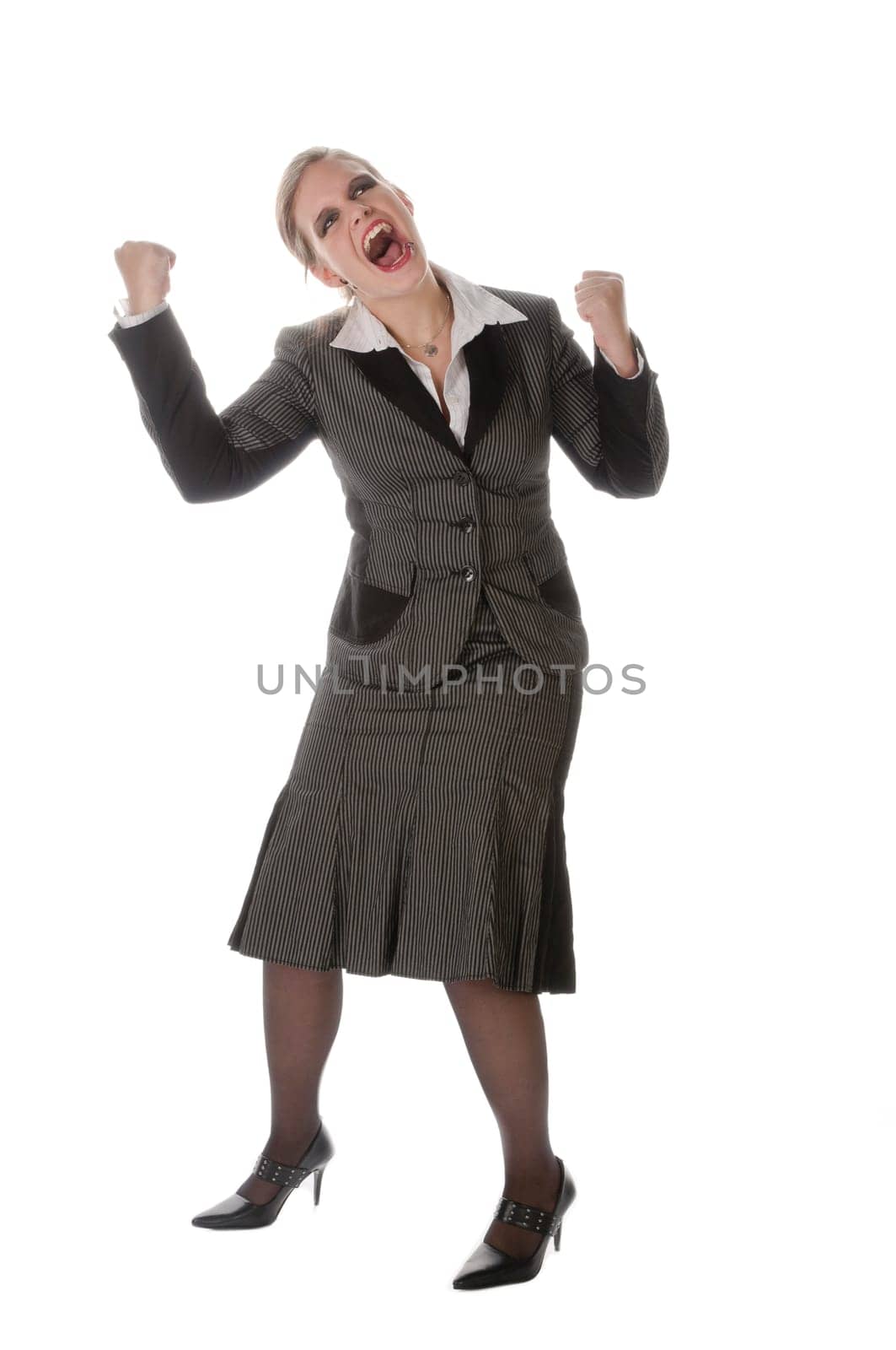 Young woman in grey business suit and high heels is horrified and desperate against a white background
