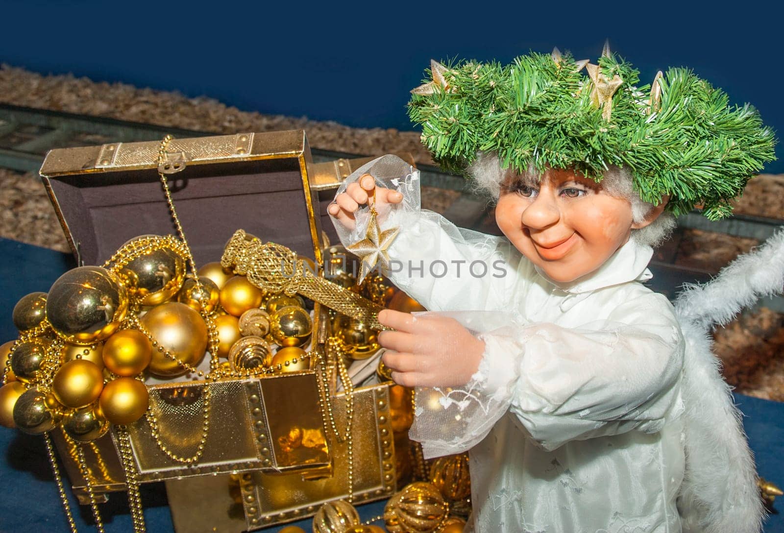 Nativity Angel  and a chest with Christmas decotaton gold glass balls