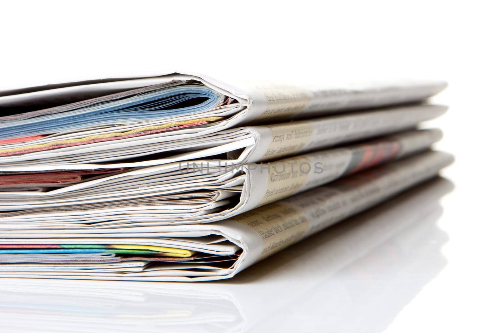 several newspapers stacked with white background