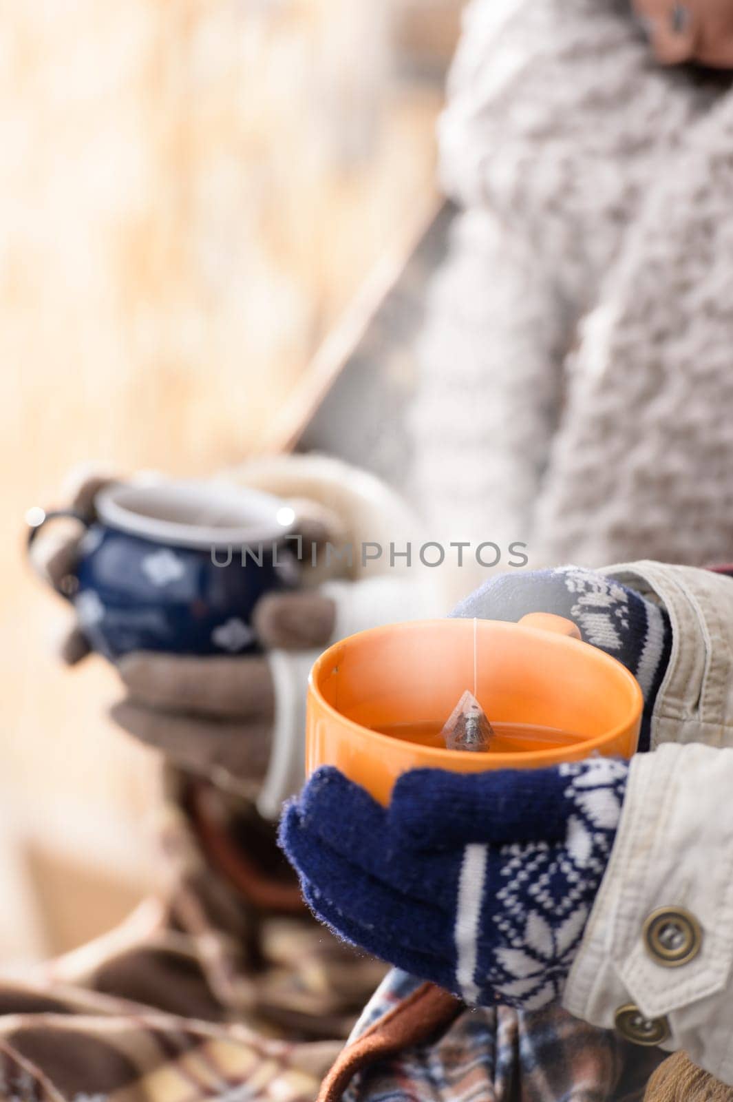 Steaming cups of tea winter hands holding countryside fashion