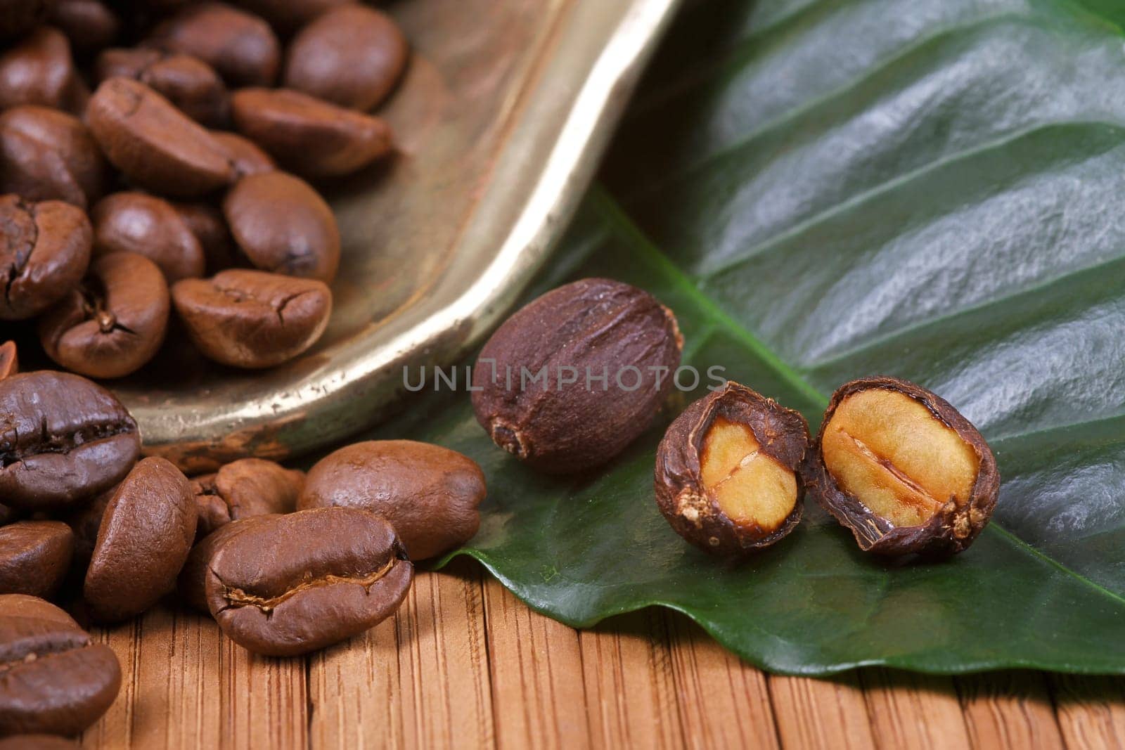 Fresh coffee beans with leaf and pan