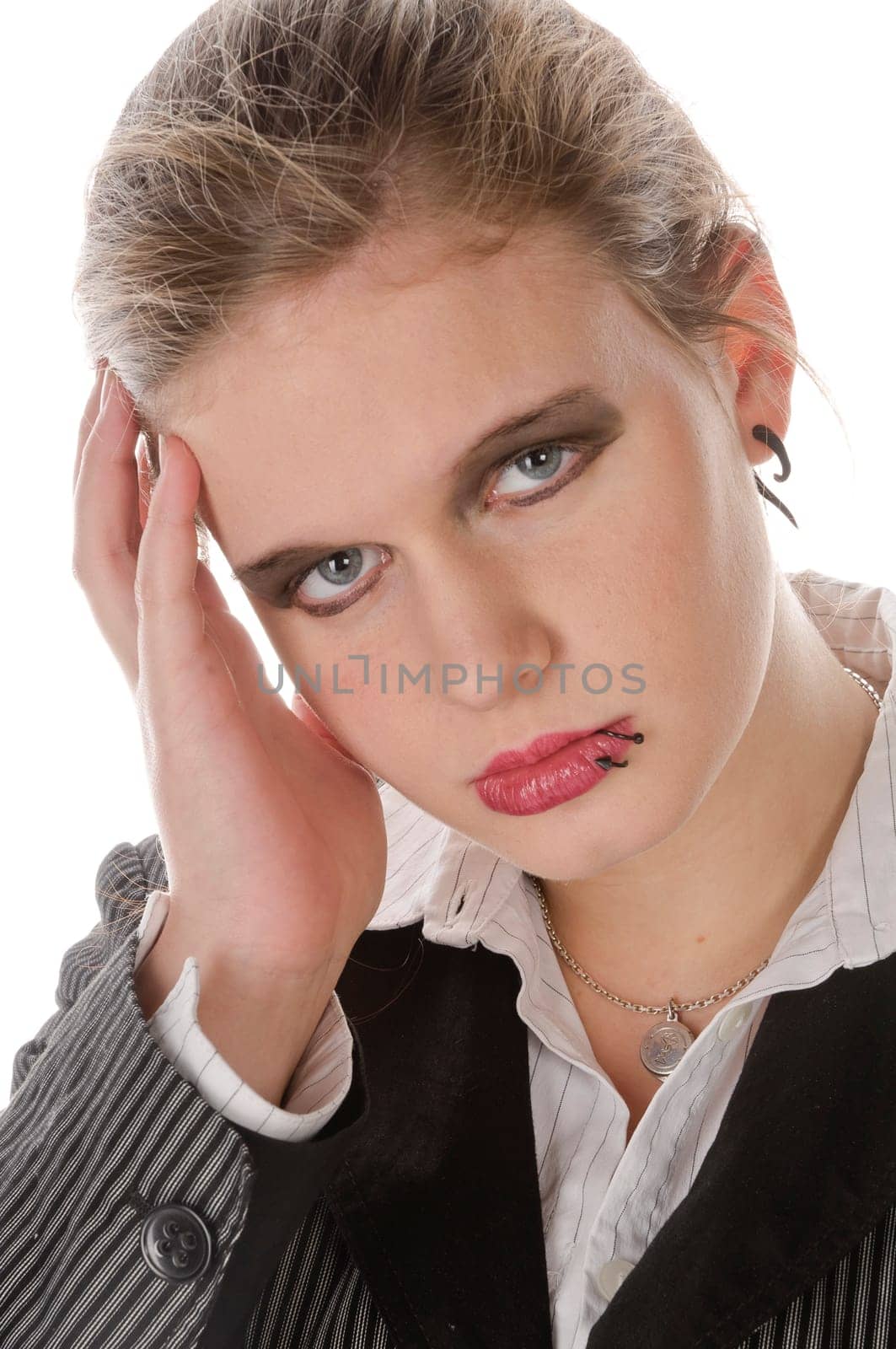 Young woman in grey business suit and high heels is annoyed and has head clipping against a white background,portrait