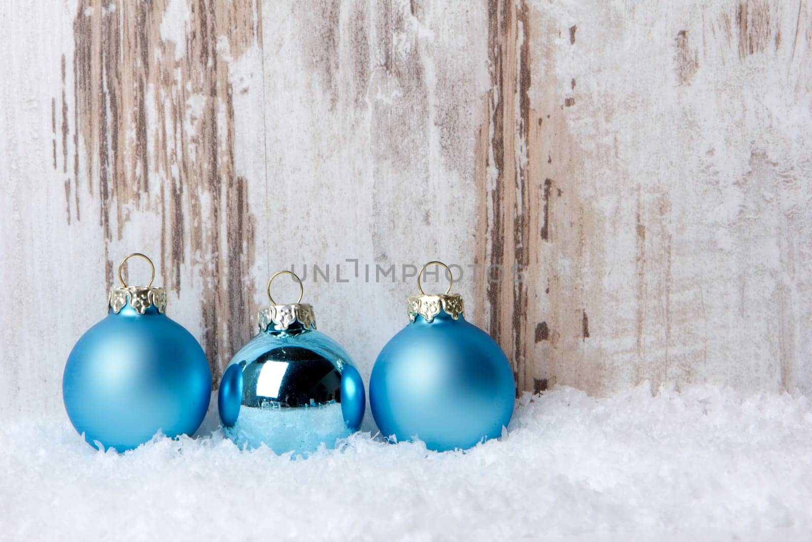 Christmas,decoration with wooden background,snow and Christmas baubles turquoise