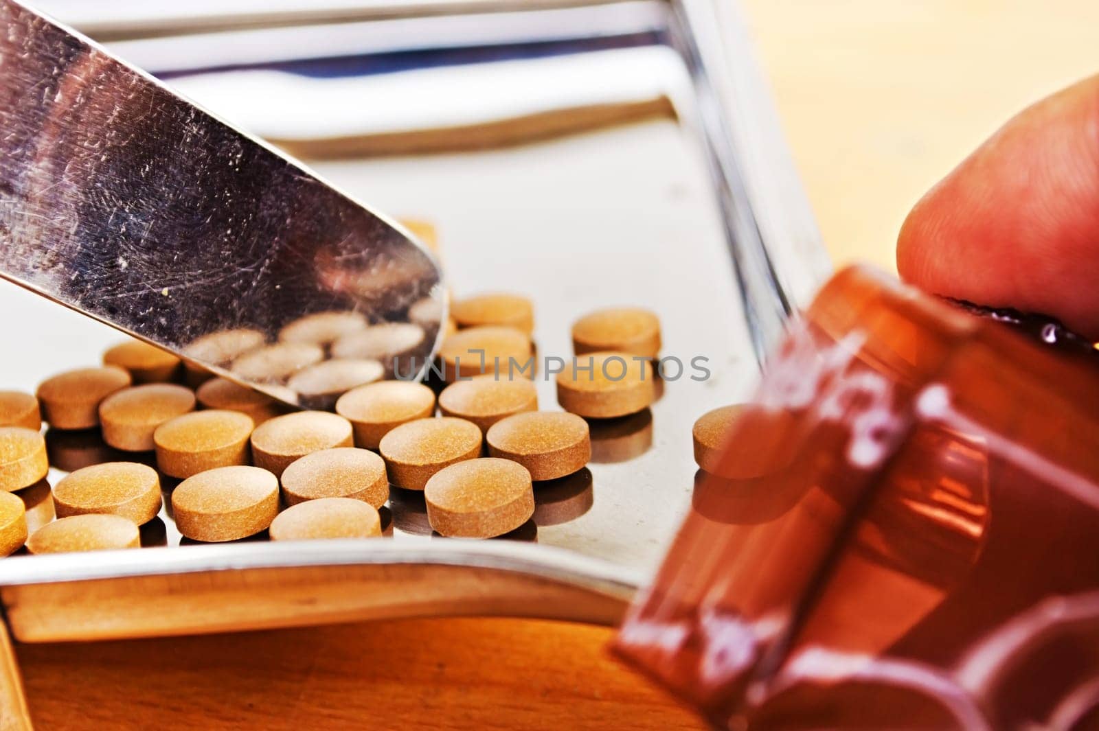 Close up of Counting tablets medical pills on stainless steel tray.(Health care and medical concept)