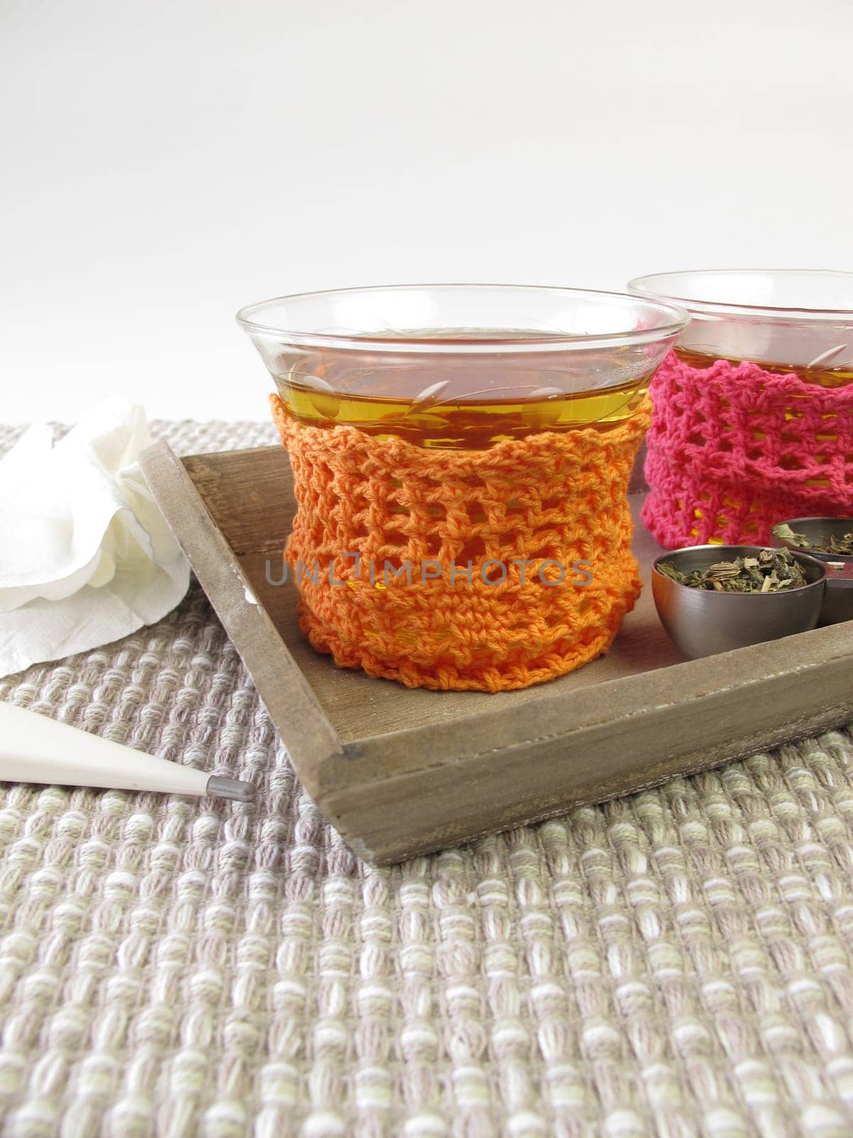 Cold tea in a glass with crocheted tea warmer