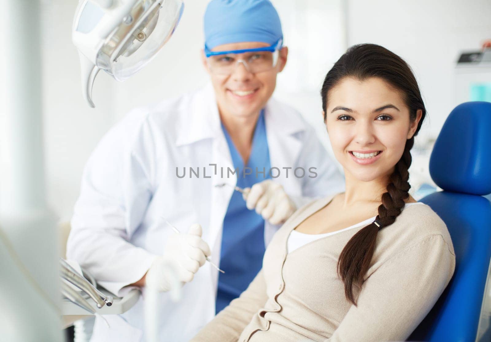 Happy girl looking at camera with toothy smile at the dentist’s