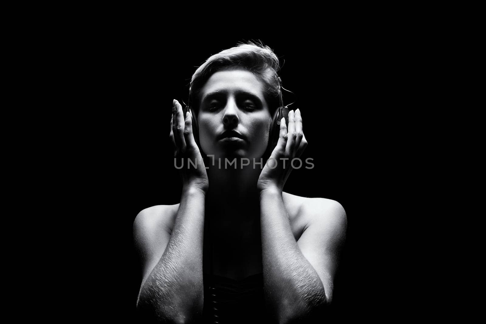 Young woman listens to music in black and white