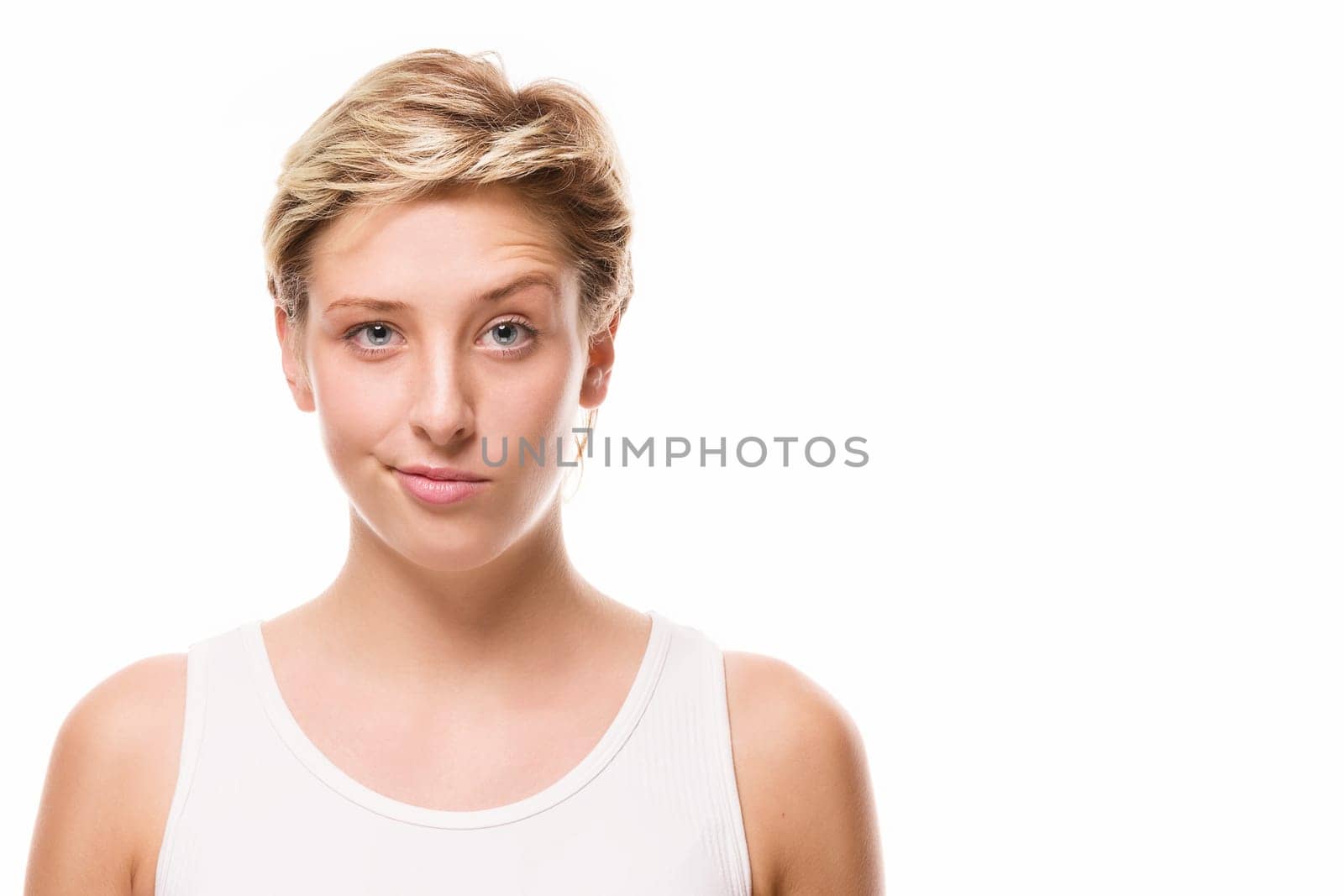 Young woman raises her eyebrow on a white background