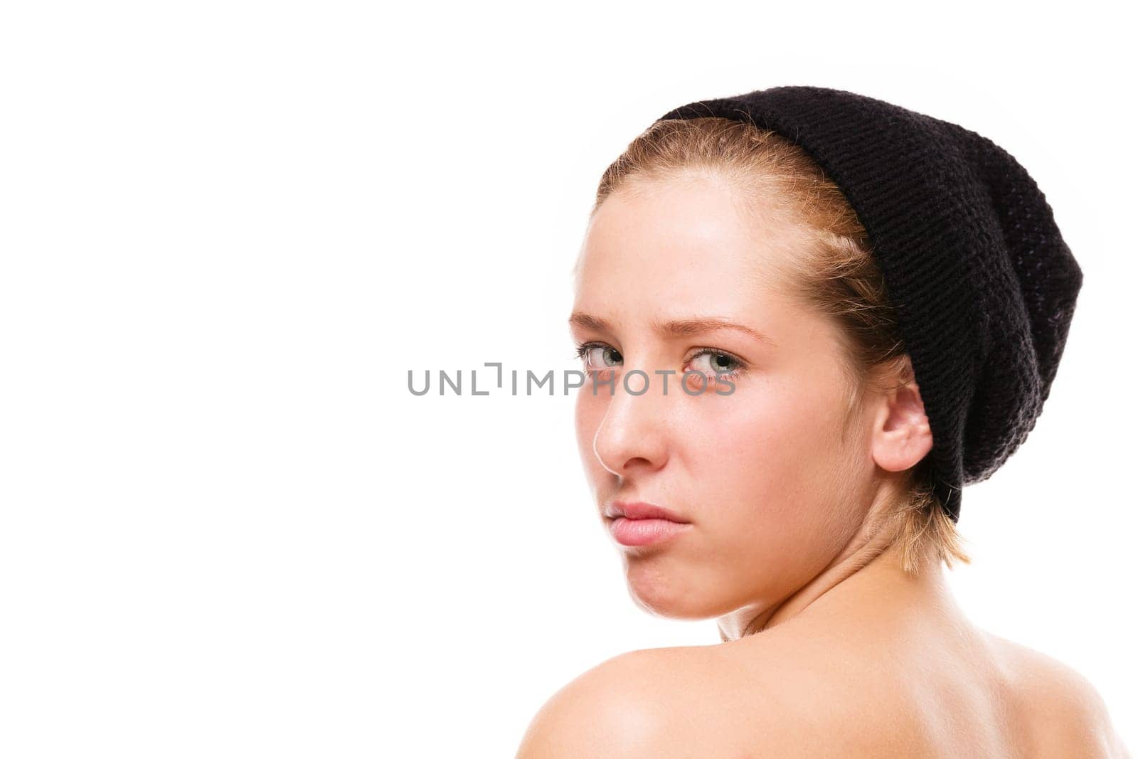 Angry woman looks over her shoulder on a white background