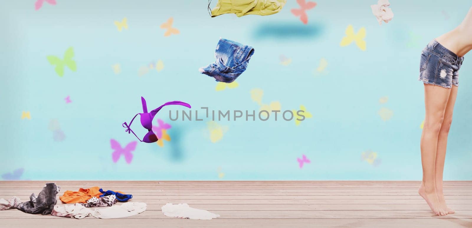 Young woman throwing clothes out of her closet