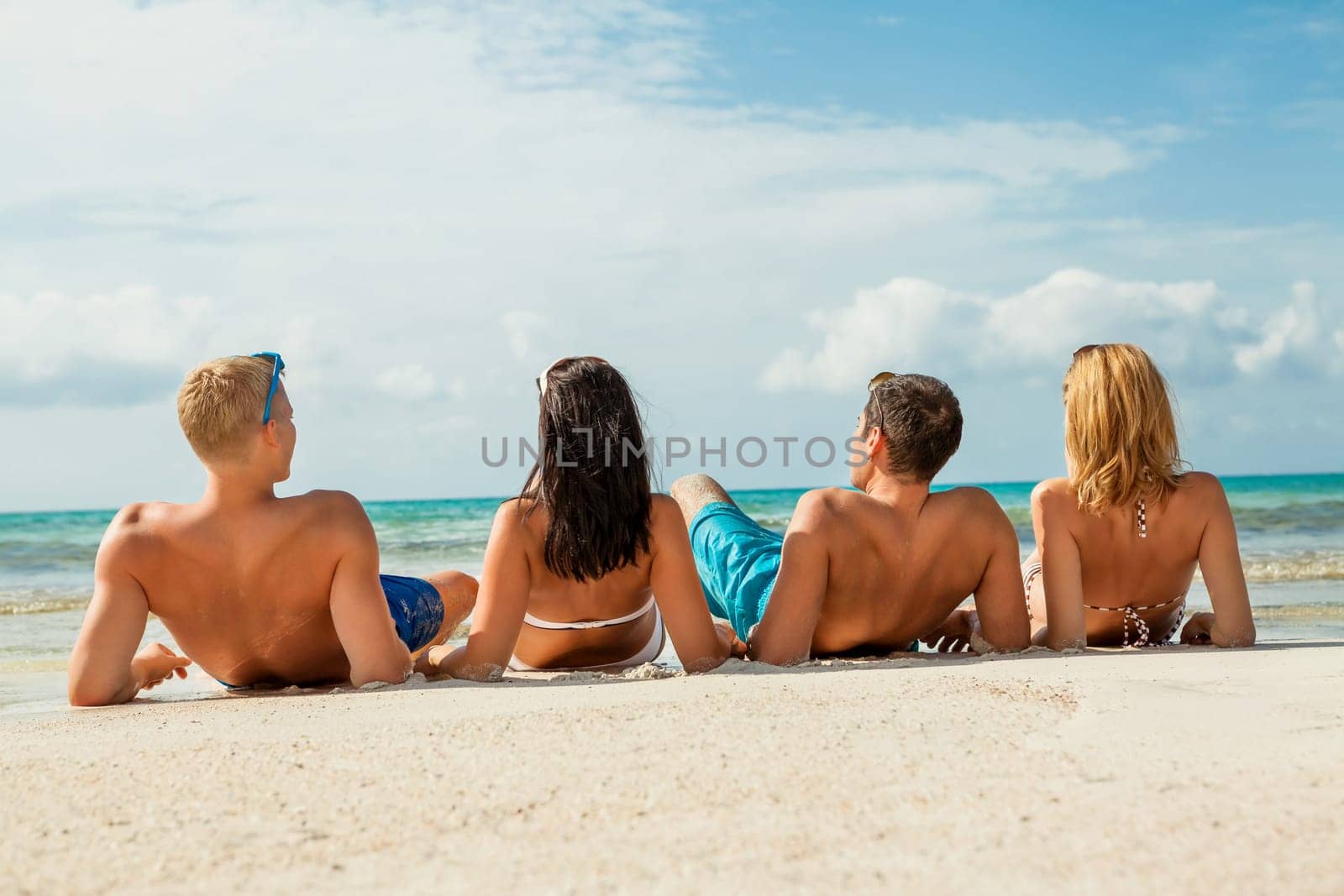 group laughing young people on the beach during summer vacation leisure lifestyle