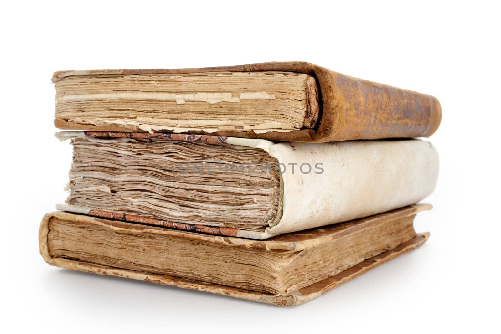 three antique books on a pile with all the crumpled pages