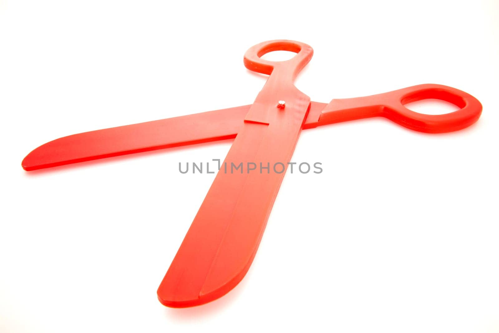 A pair of big plastic red scissors