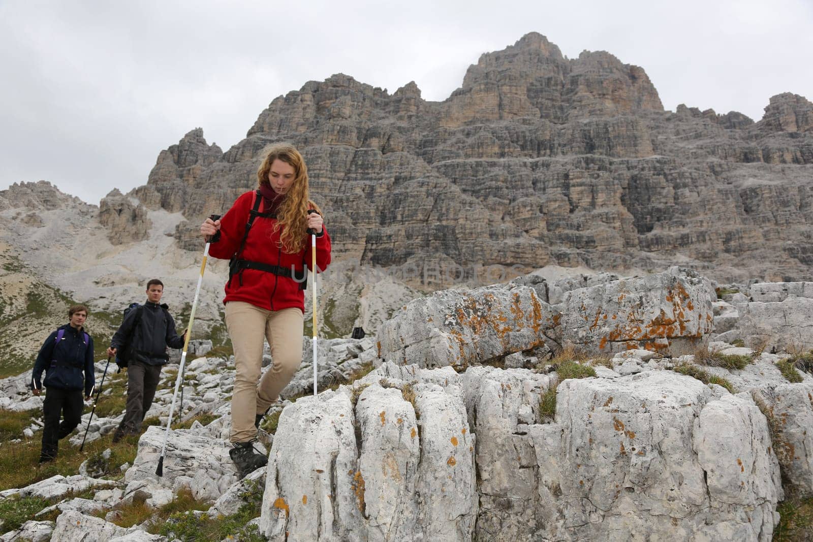 Young mountaineers hike in the mountains Alps Dolomites
