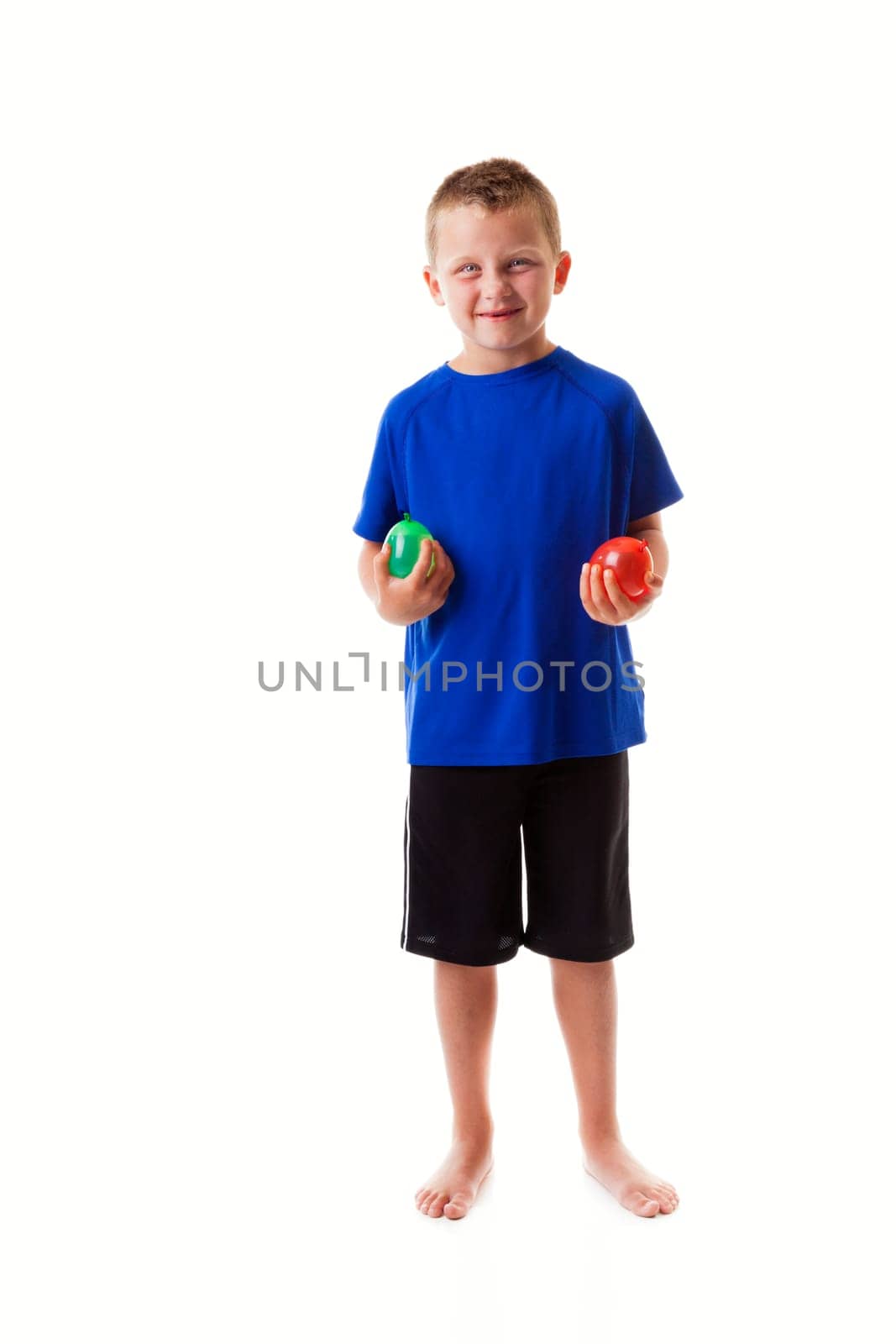 Boy holding water balloons isolated on white background
