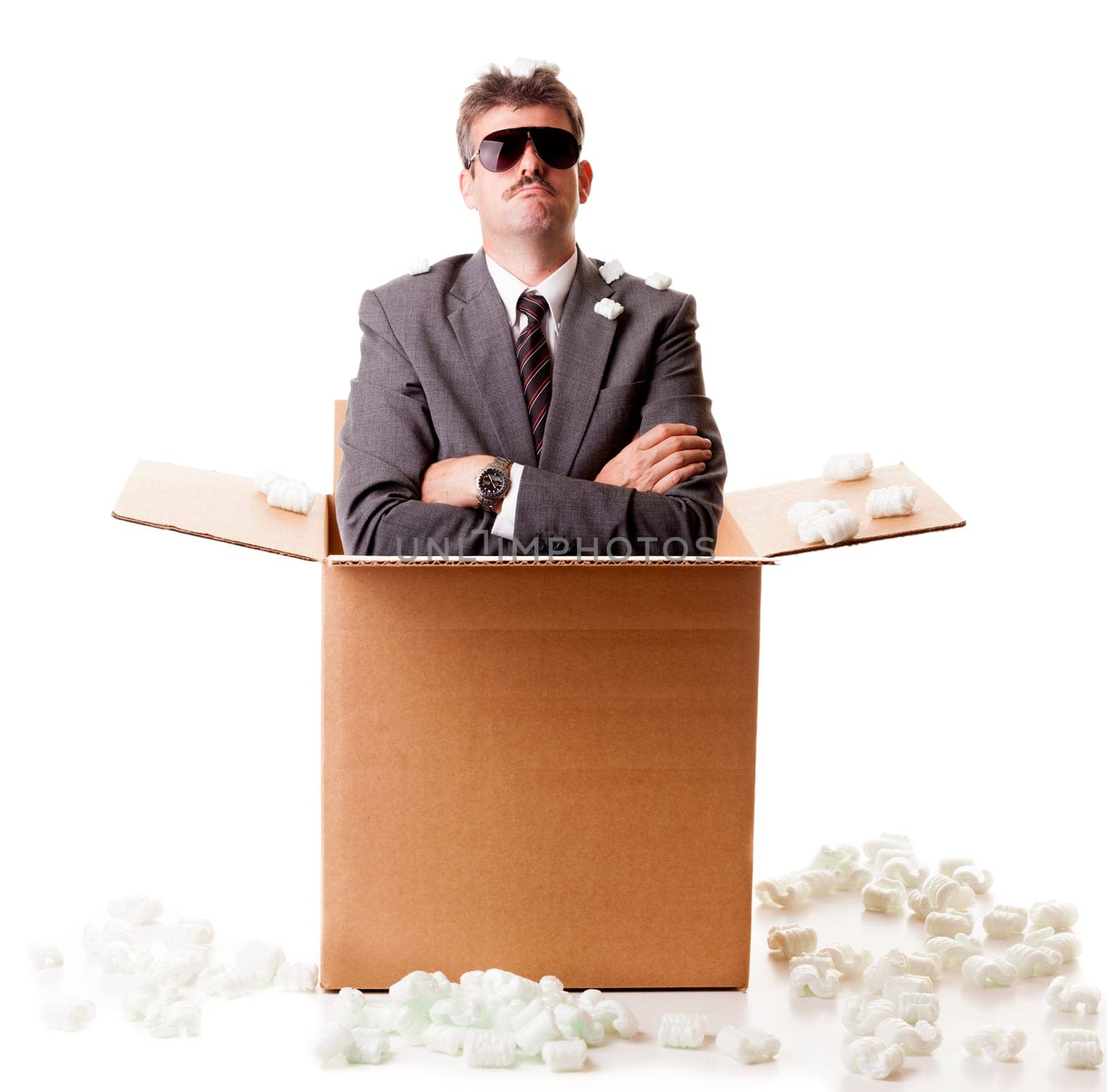 Businessman appears out of the shipping box. Isolated on white background