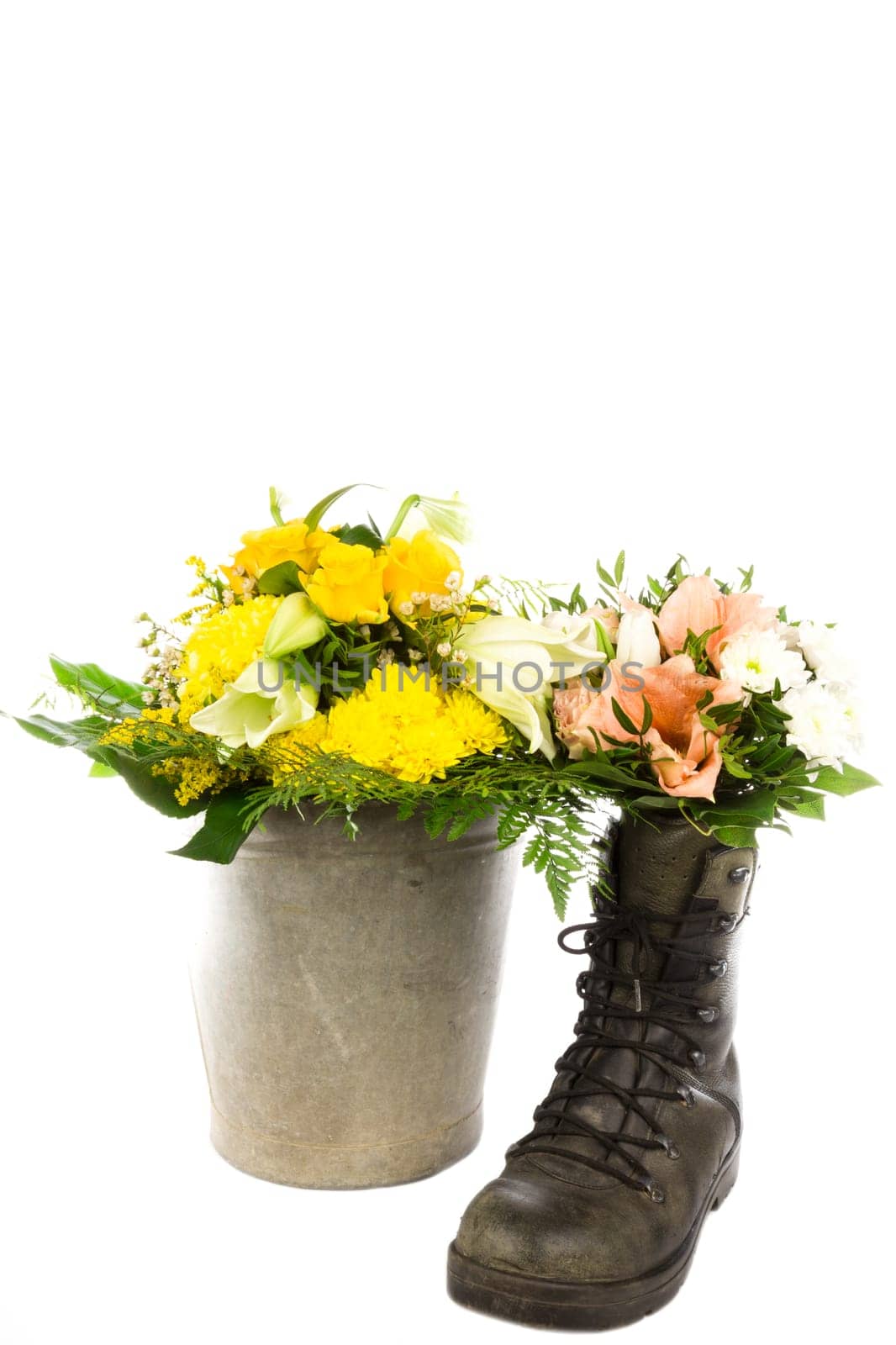 An old boot and bucket with a bouquet of flowers
