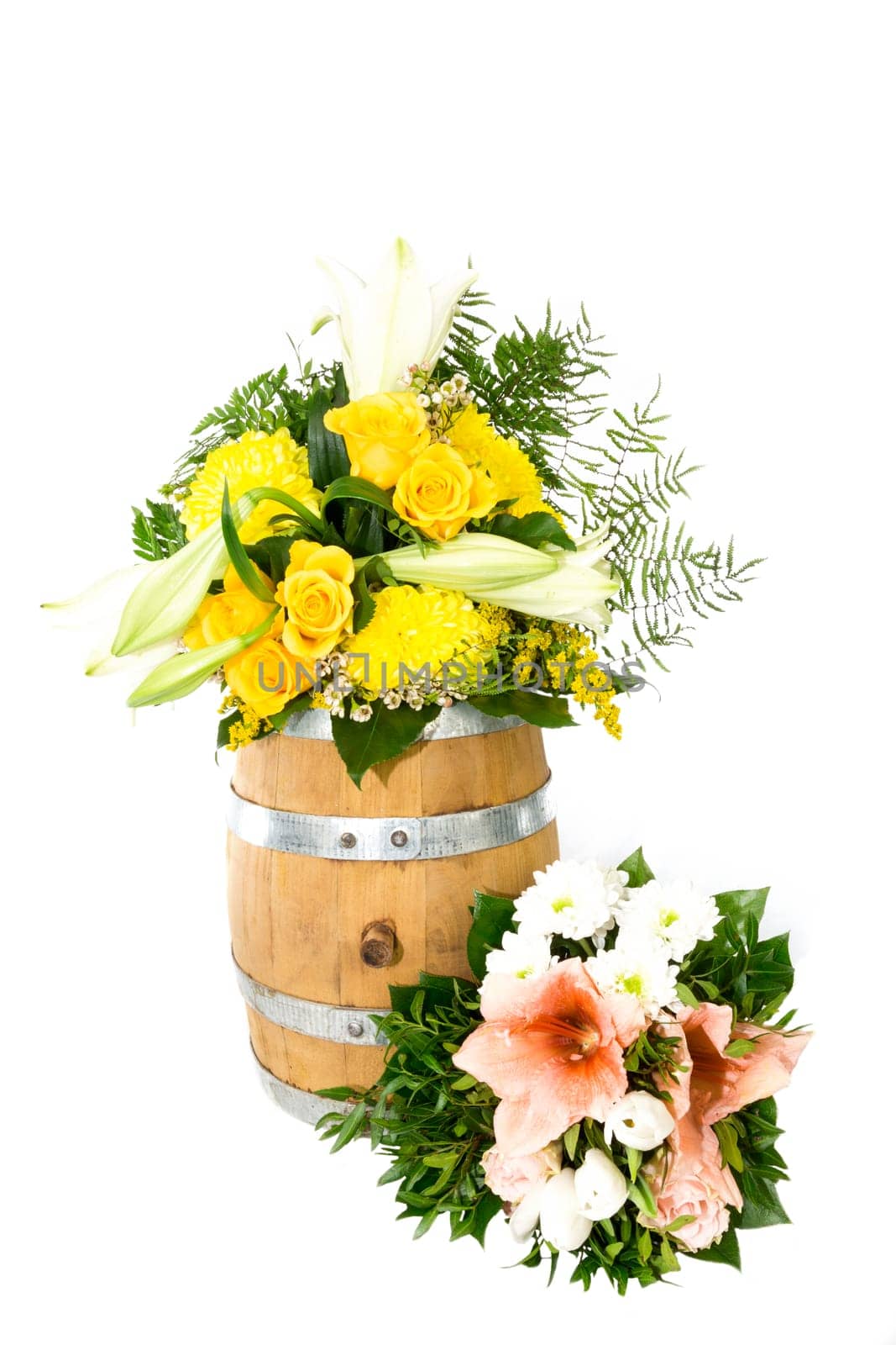 Bouquet of flowers on and next to a small wooden barrel