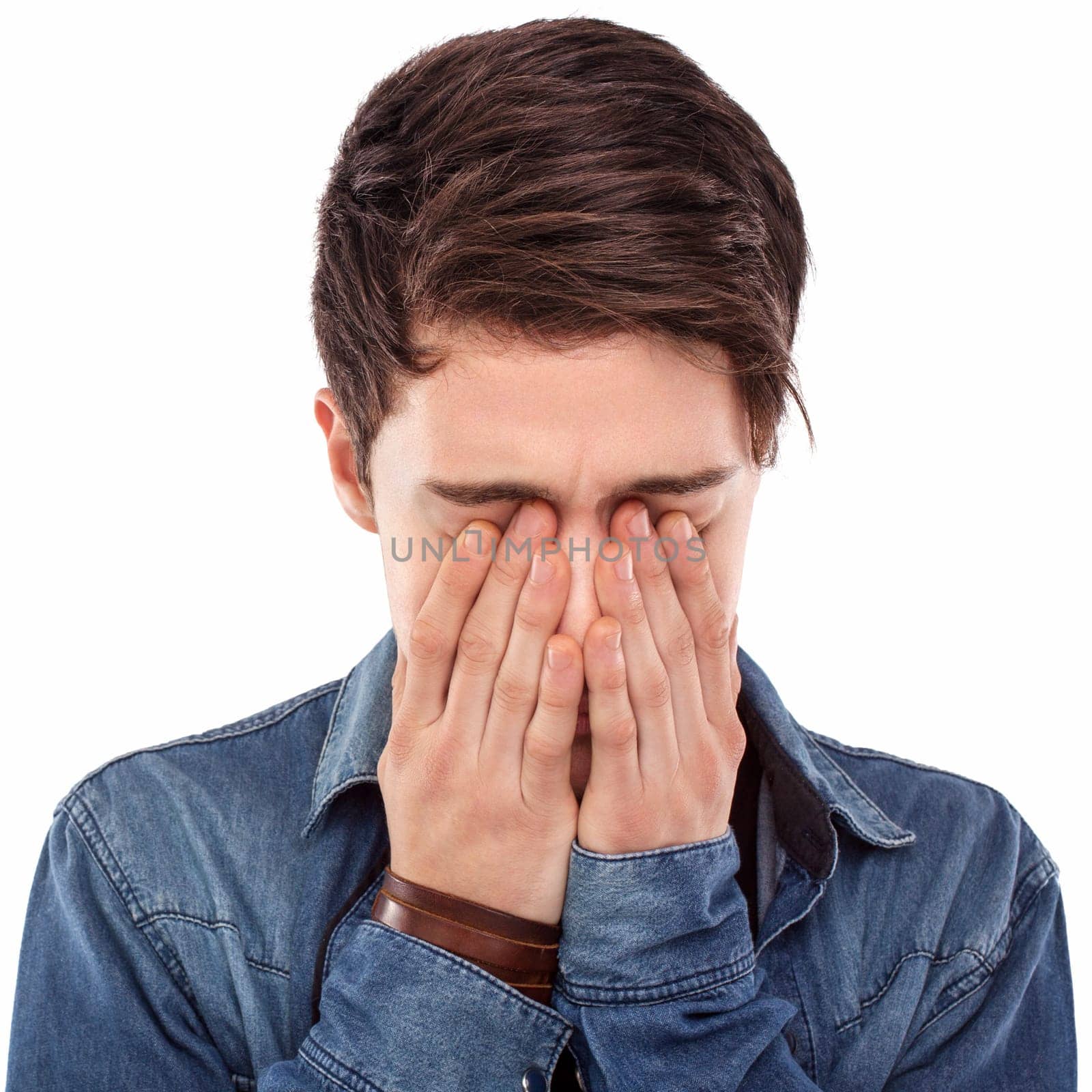 Young man hiding his face with his hands