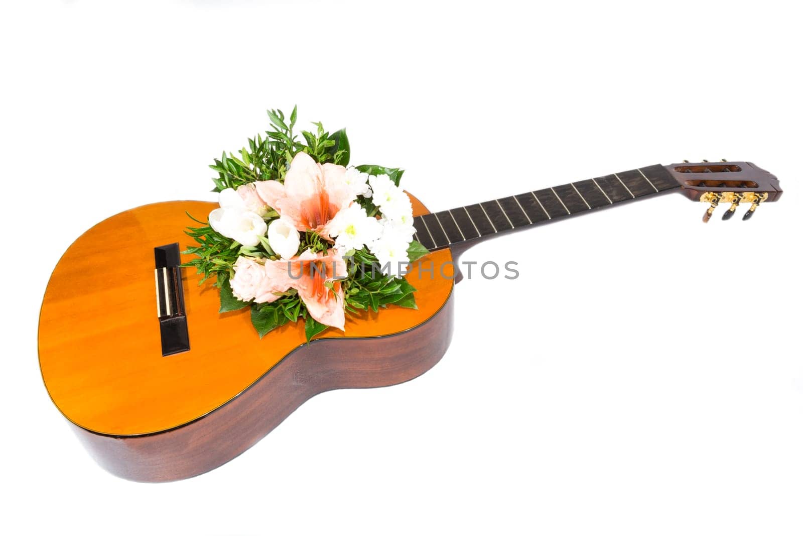 A bouquet of flowers is in a guitar