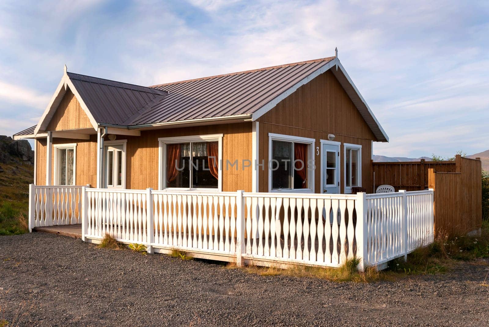 wooden cottage with a white picket fence in Iceland