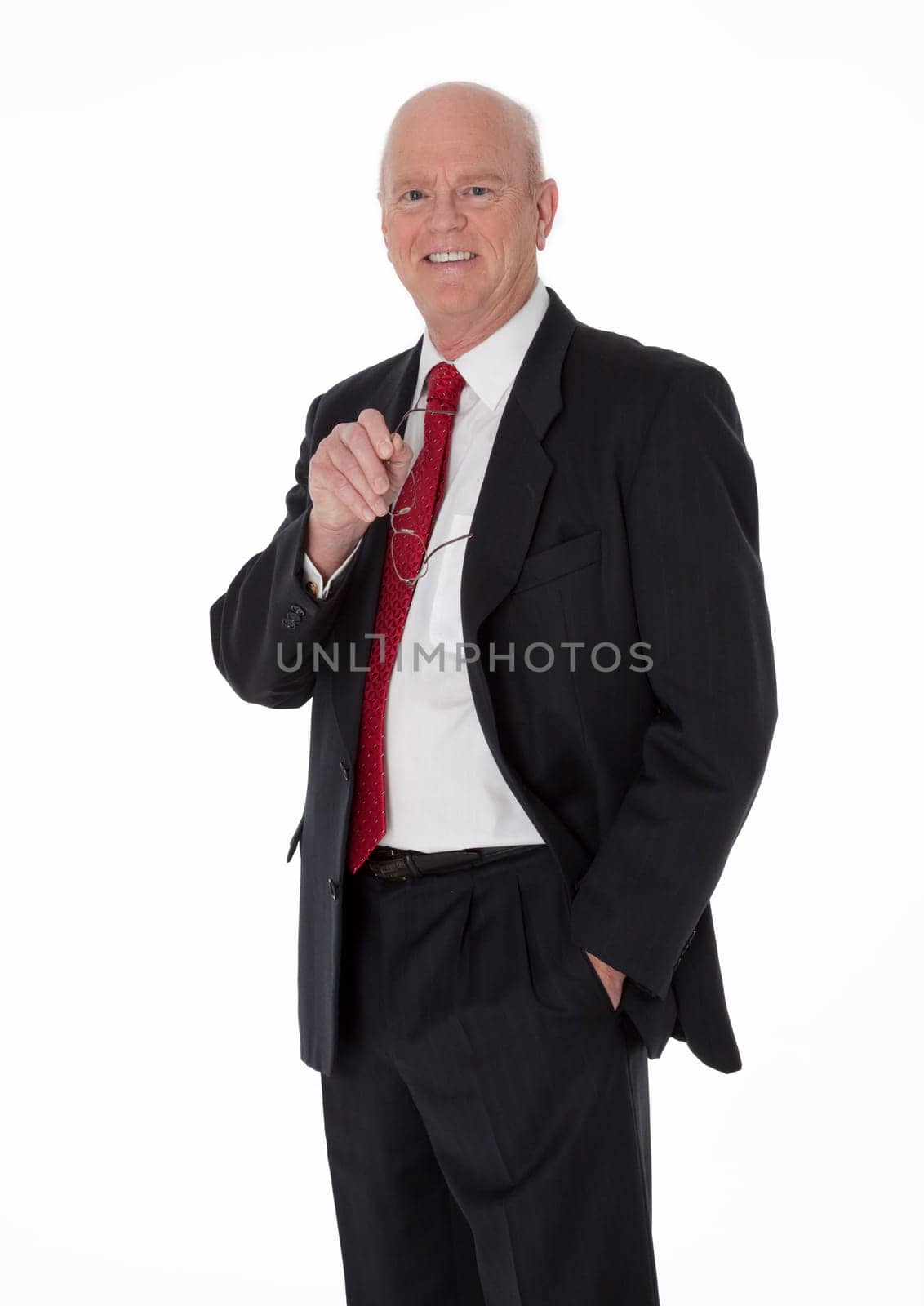 Balding cheerful mature businessman dressed in black business suit standing on white background