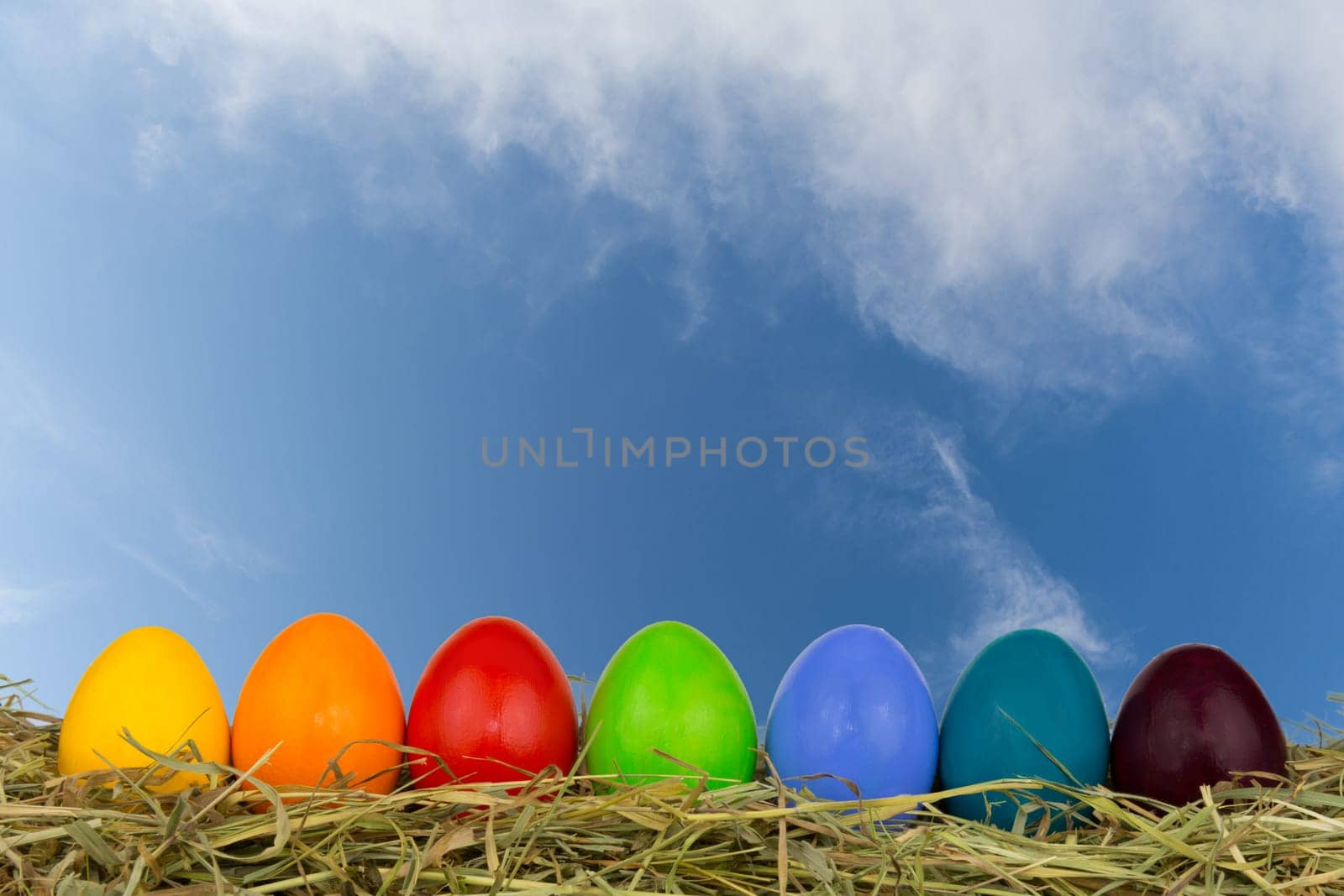 Colourful Easter eggs in the hay