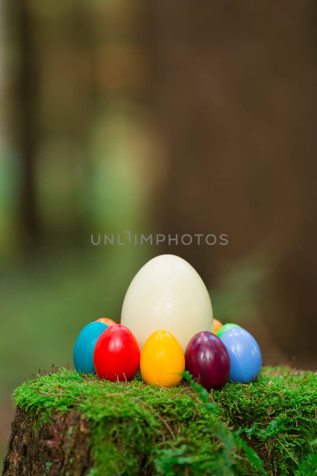 Colorful Easter eggs and a Nanduei on a tree stump